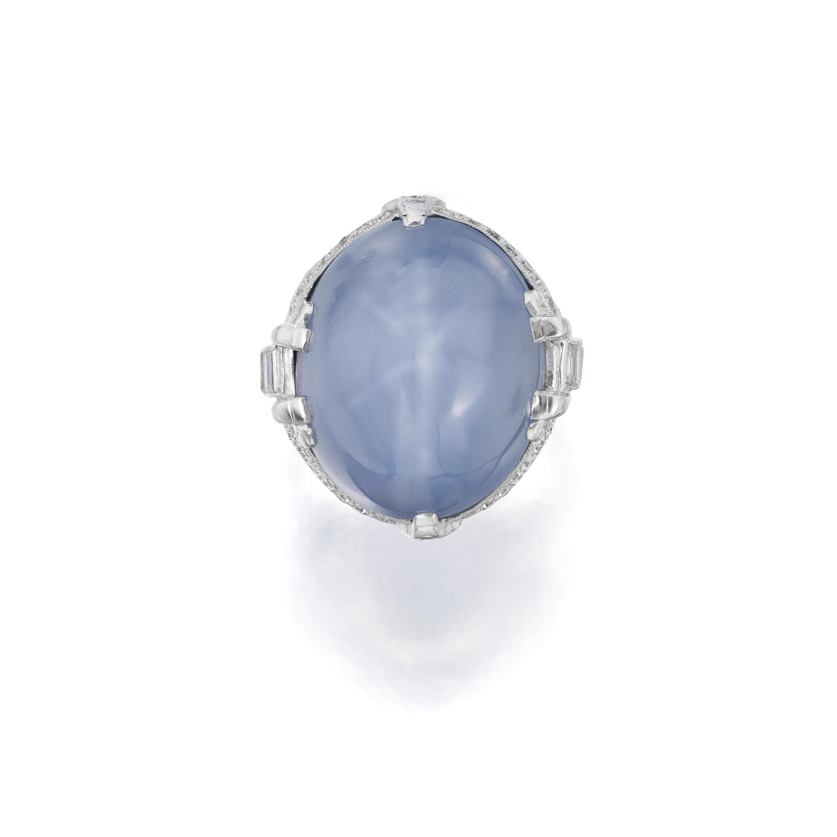 Appraisal: A STAR SAPPHIRE AND DIAMOND RING Centering an oval cabochon