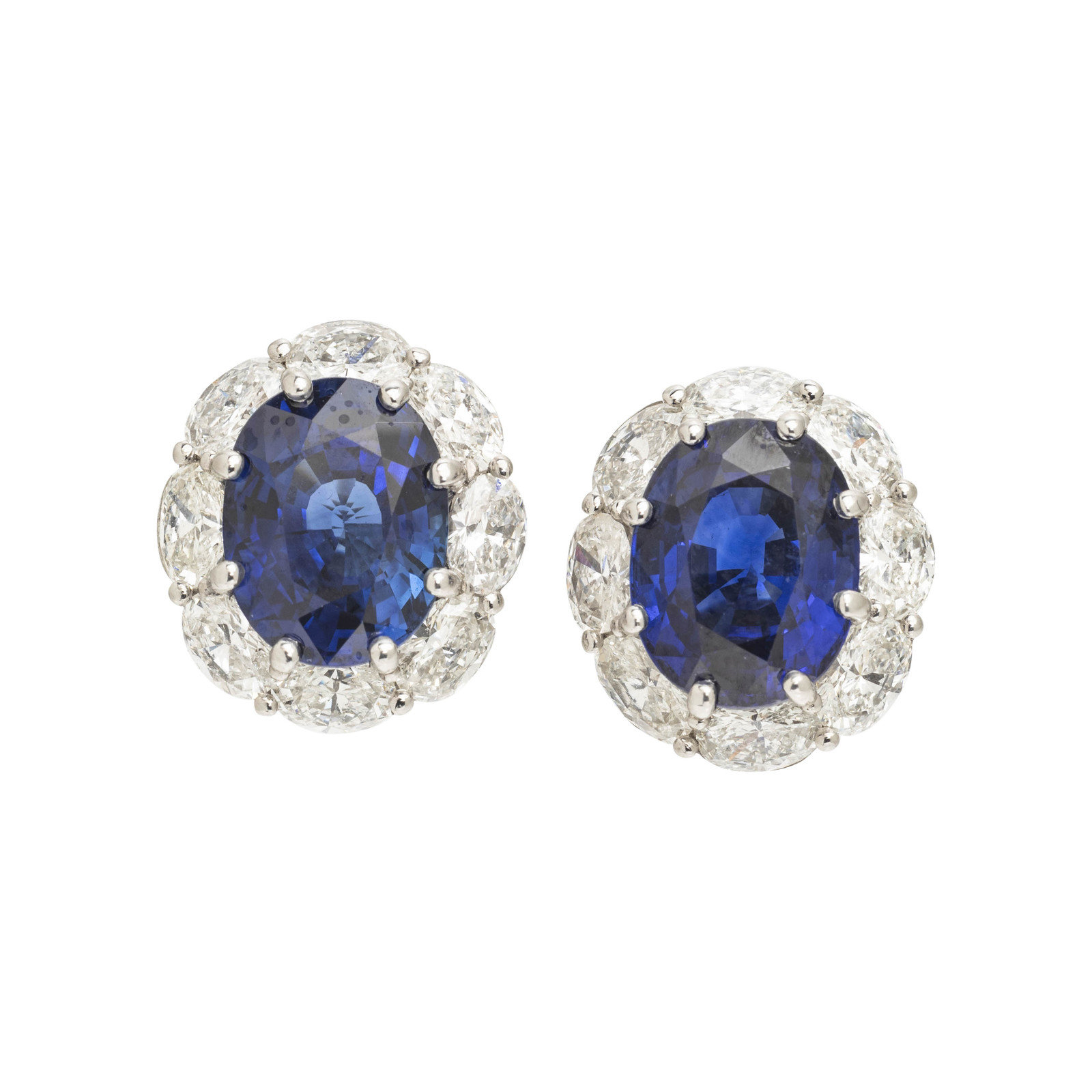 Appraisal: SAPPHIRE AND DIAMOND EARCLIPS Containing two oval mixed cut sapphires