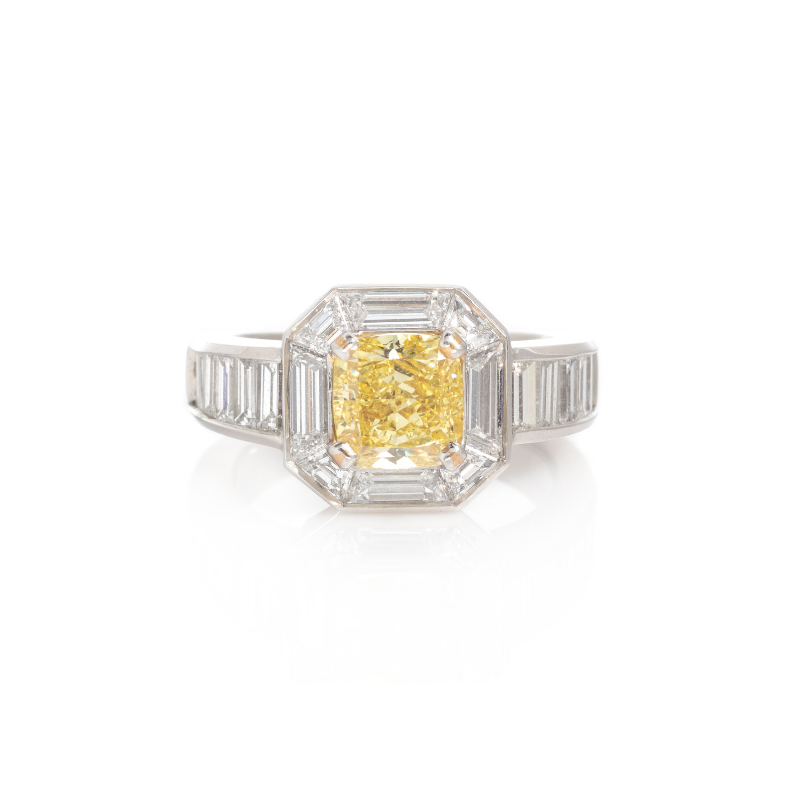 Appraisal: FANCY INTENSE YELLOW DIAMOND AND DIAMOND RING Containing one cushion