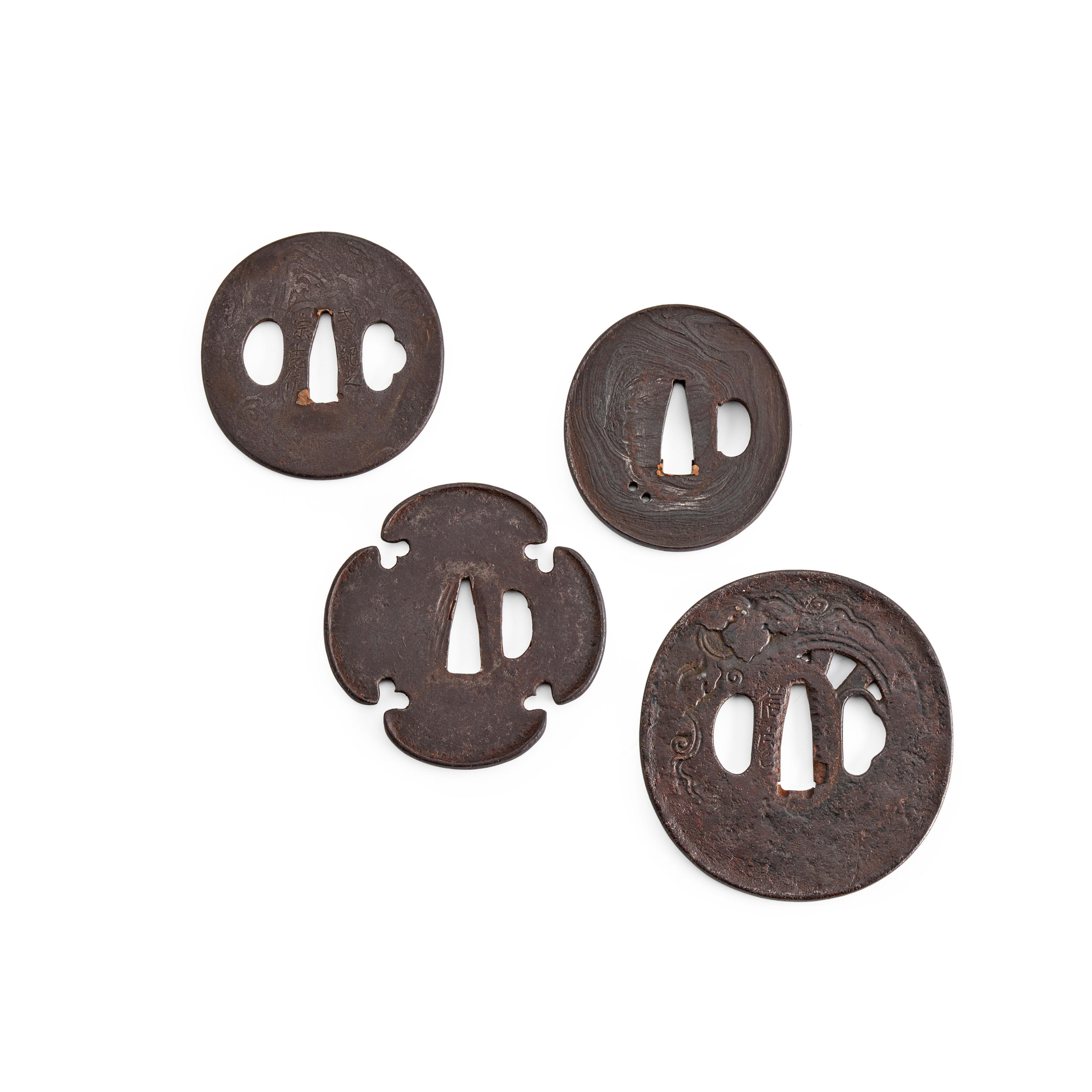 Appraisal: A GROUP OF FOUR IRON TSUBA Muromachi period - th