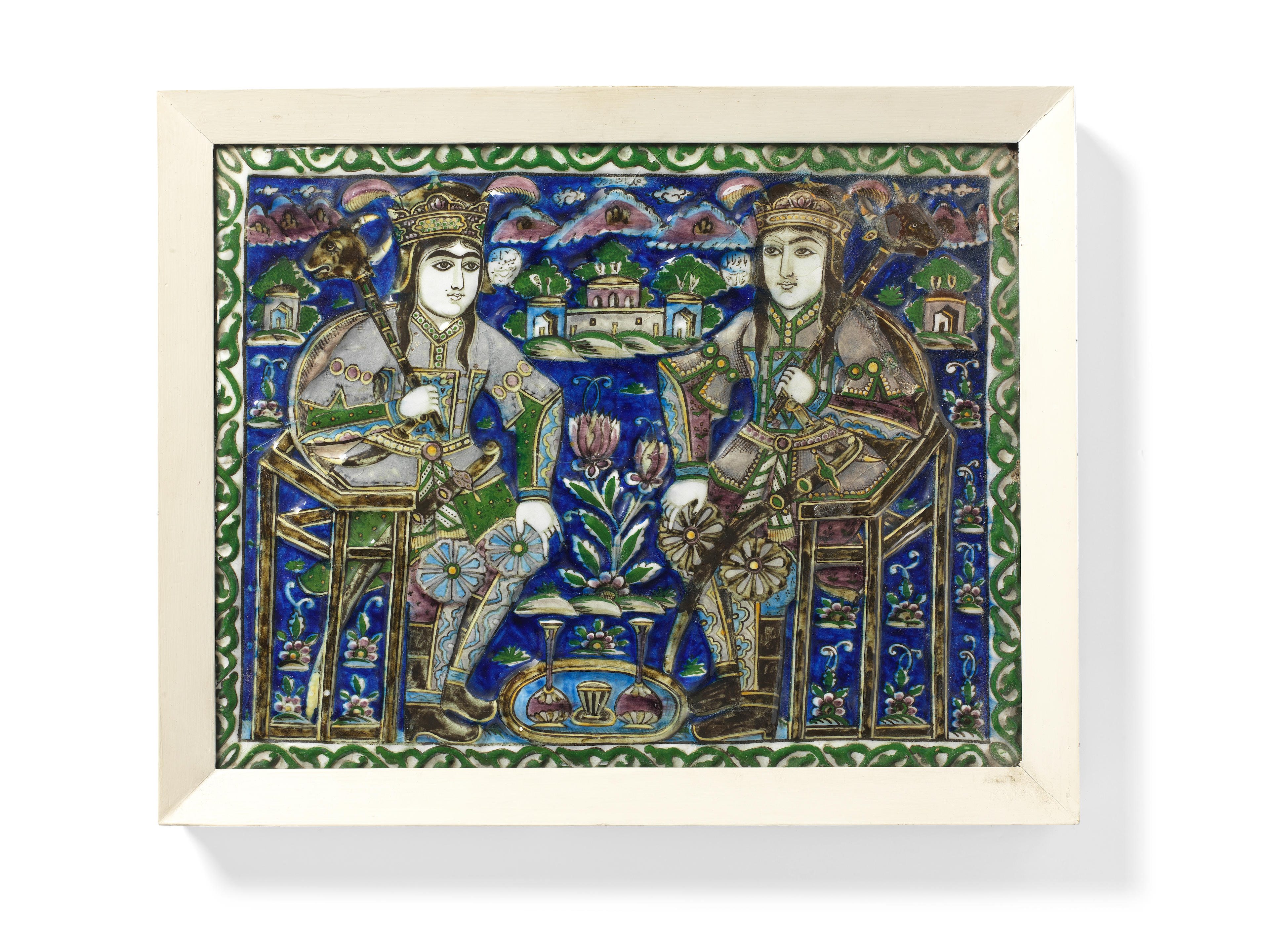 Appraisal: A QAJAR UNDERGLAZE-PAINTED MOULDED POTTERY TILE DEPICTING TWO SEATED WARRIORS