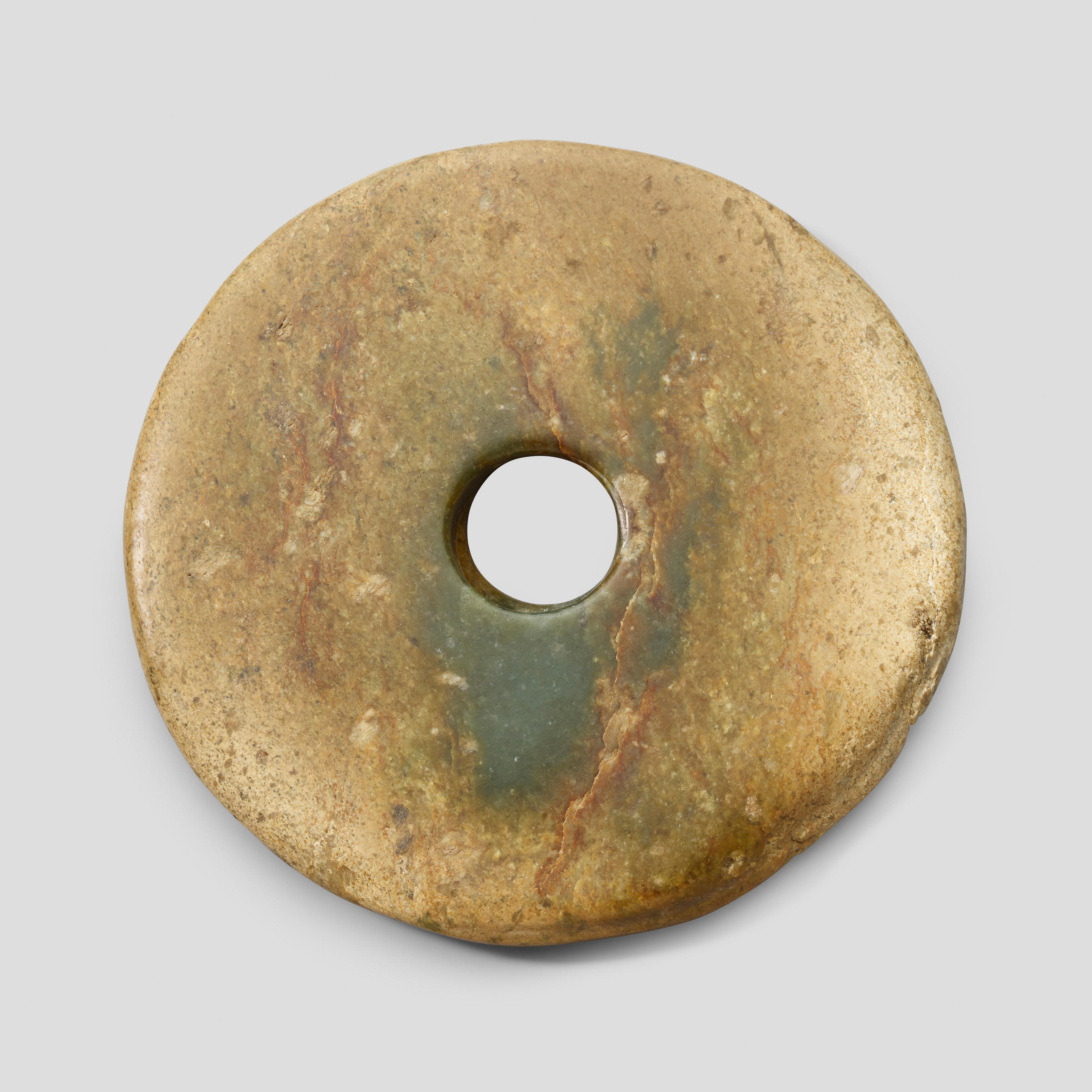 Appraisal: A GREEN JADE BI DISC Probably Western Zhou dynasty The