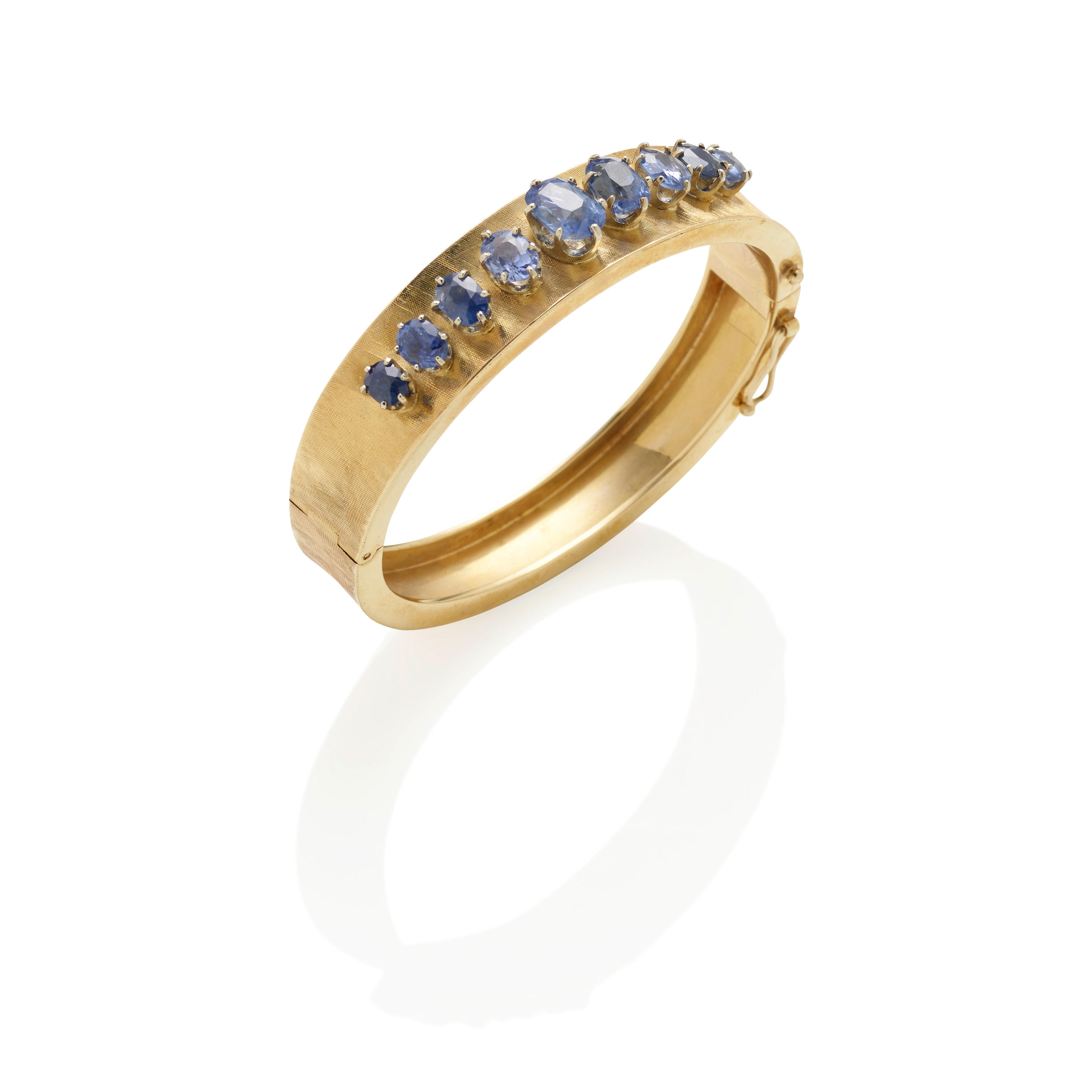 Appraisal: A K GOLD AND SAPPHIRE BRACELET Featuring nine graduated cushion-cut