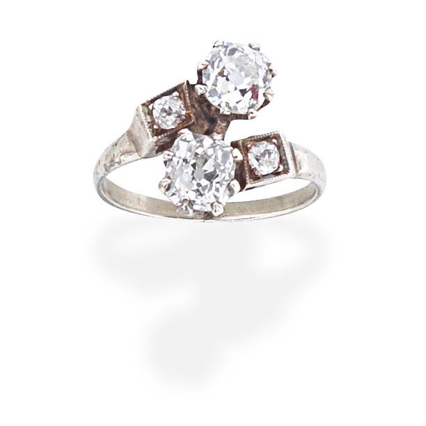 Appraisal: DIAMOND CROSSOVER RING Set with cushion-shaped diamonds principal diamonds approx