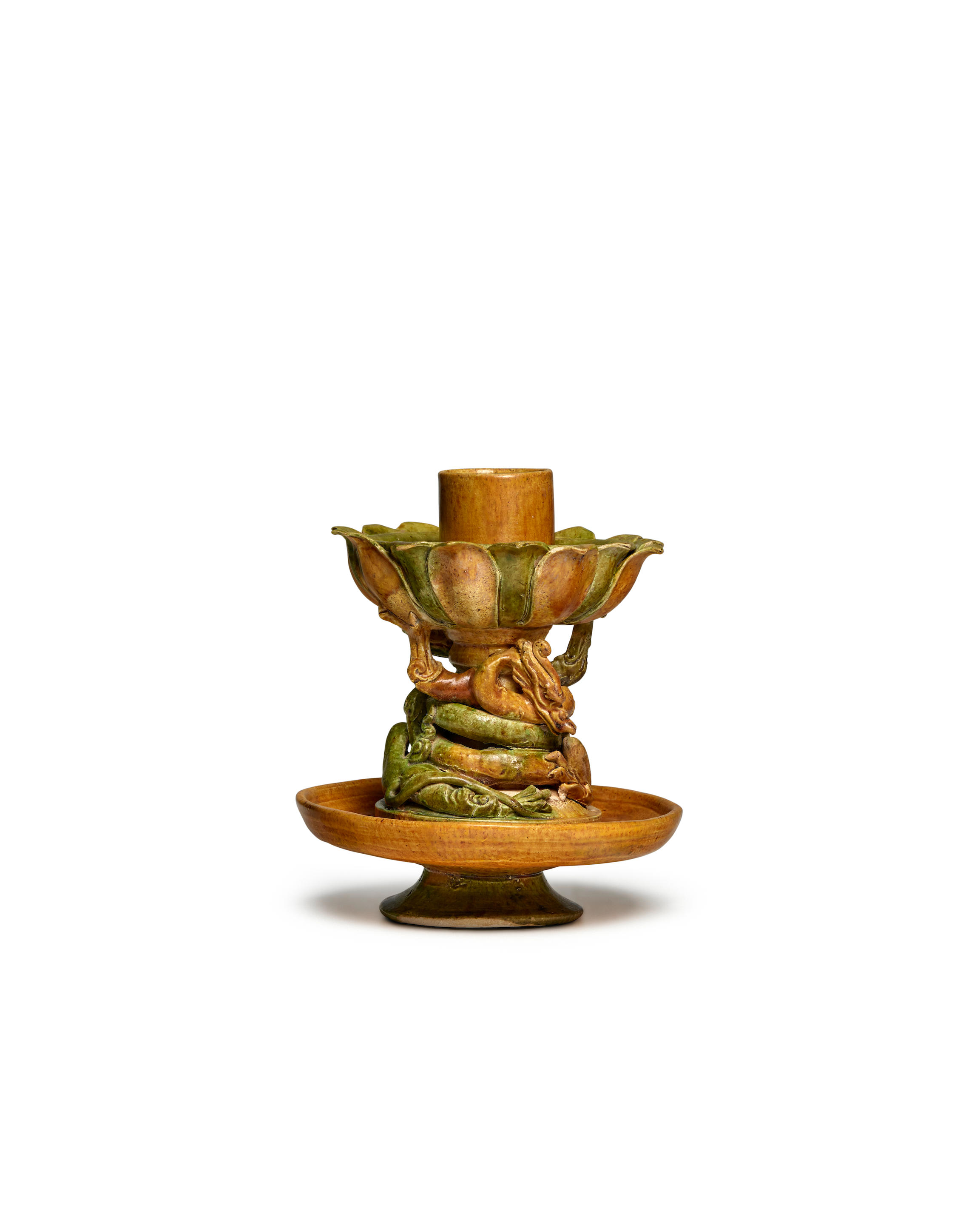 Appraisal: A RARE GREEN AND OCHRE-GLAZED DRAGON LOTUS-FORM CANDLEHOLDER Tang Dynasty