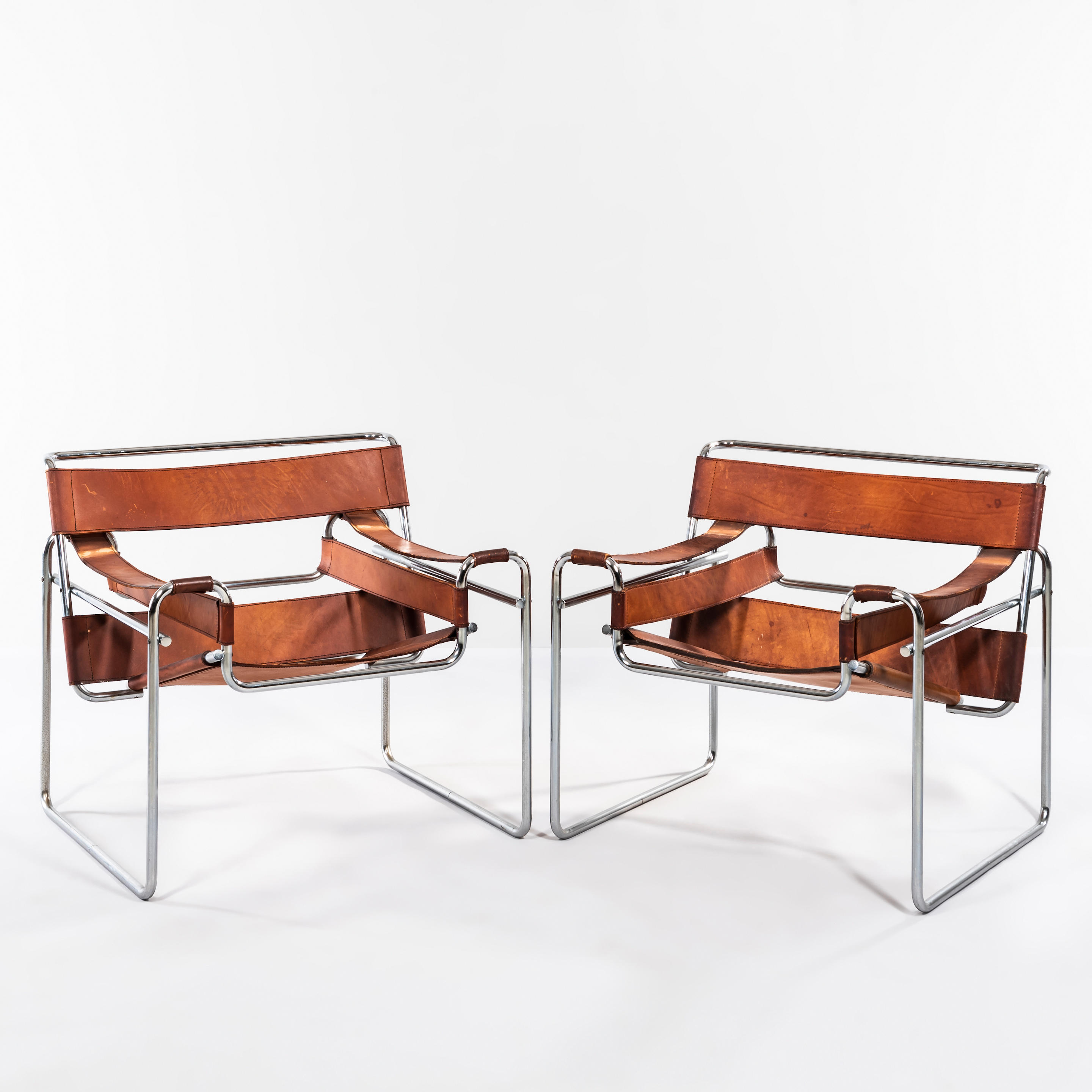 Appraisal: PAIR OF WASSILY-STYLE LOUNGE CHAIRS leather and chromed steel unmarked