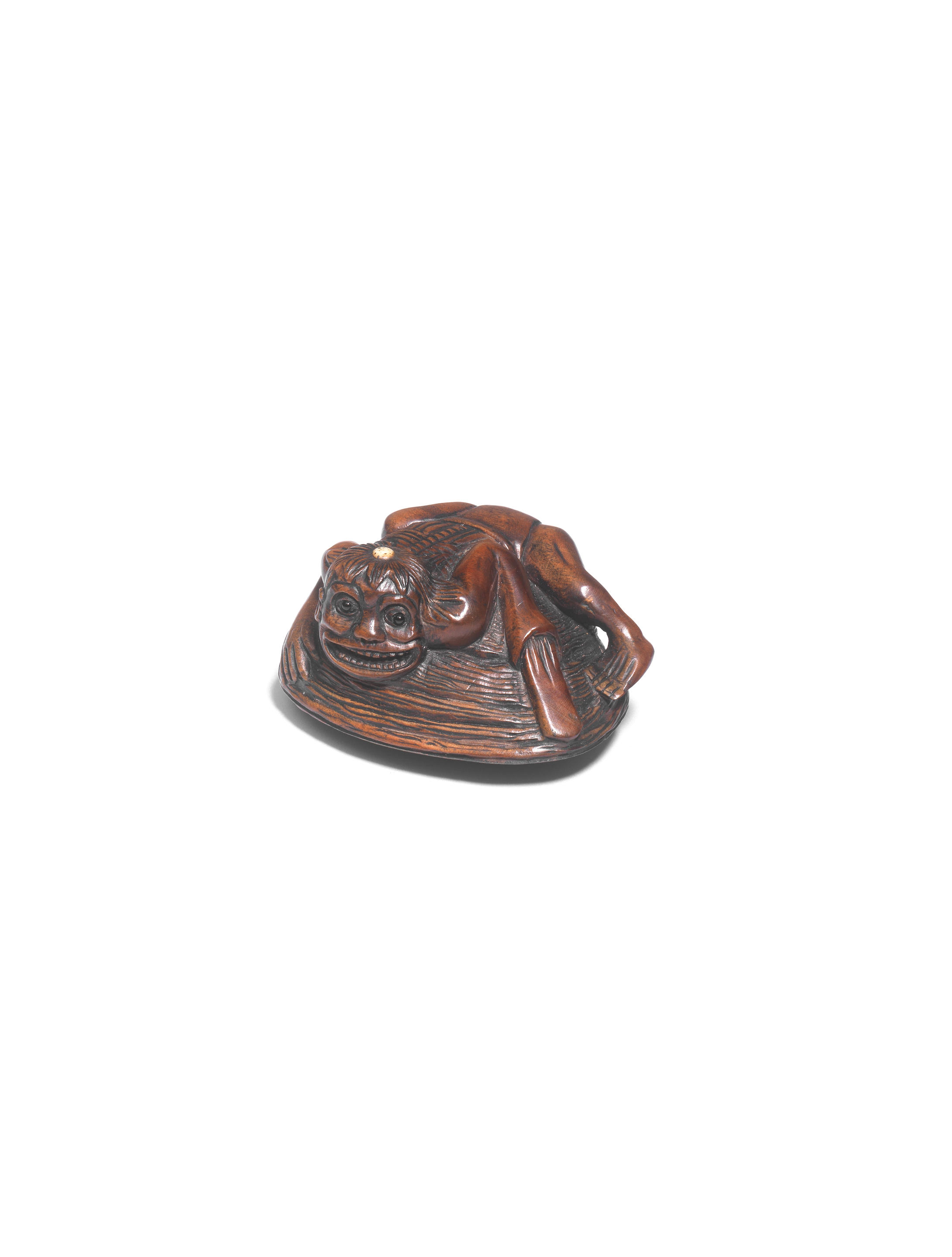 Appraisal: A WOOD NETSUKE OF A KAPPA ON A CLAM By