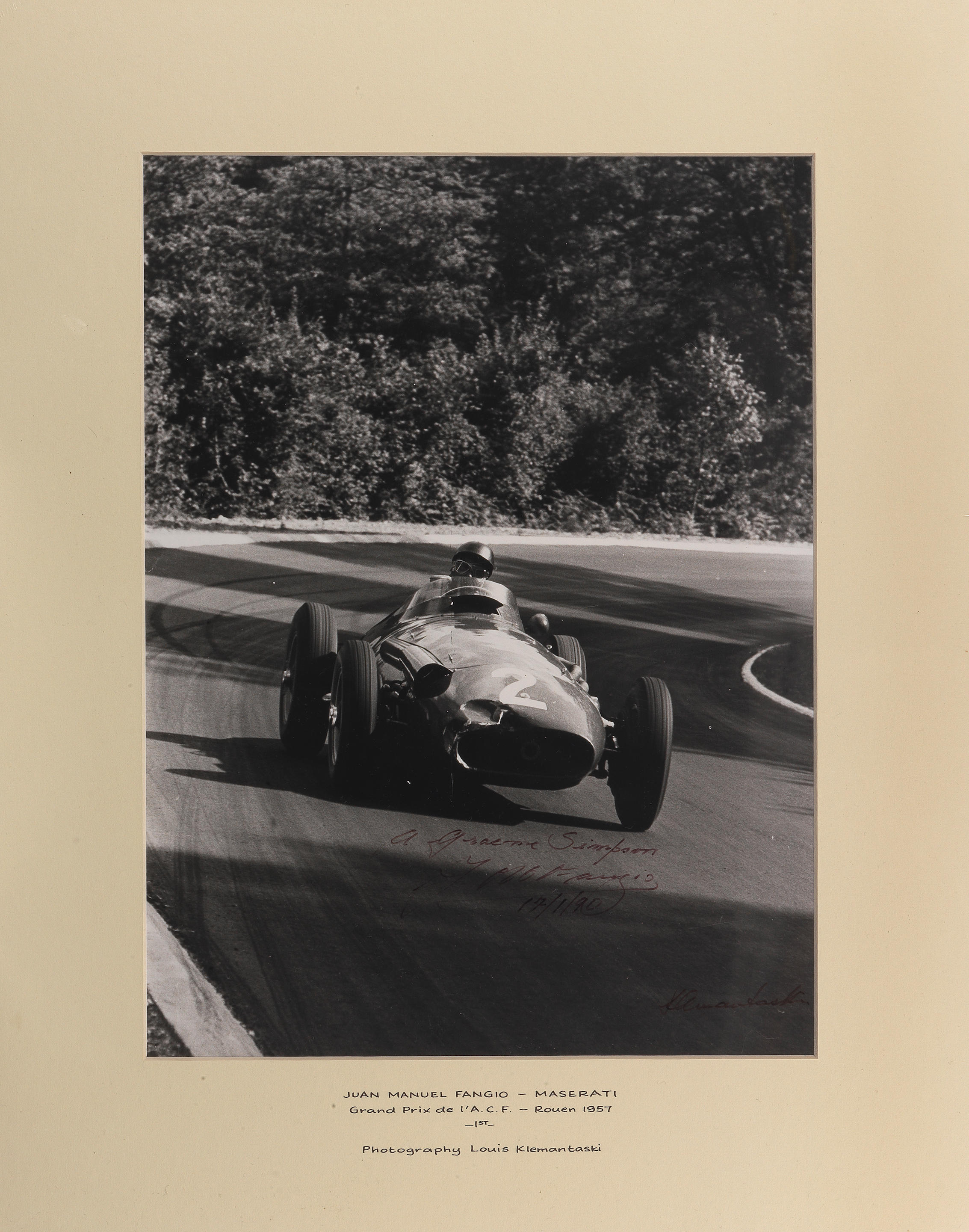 Appraisal: A SIGNED PHOTOGRAPH WITH DEDICATION OF JUAN MANUEL FANGIO IN