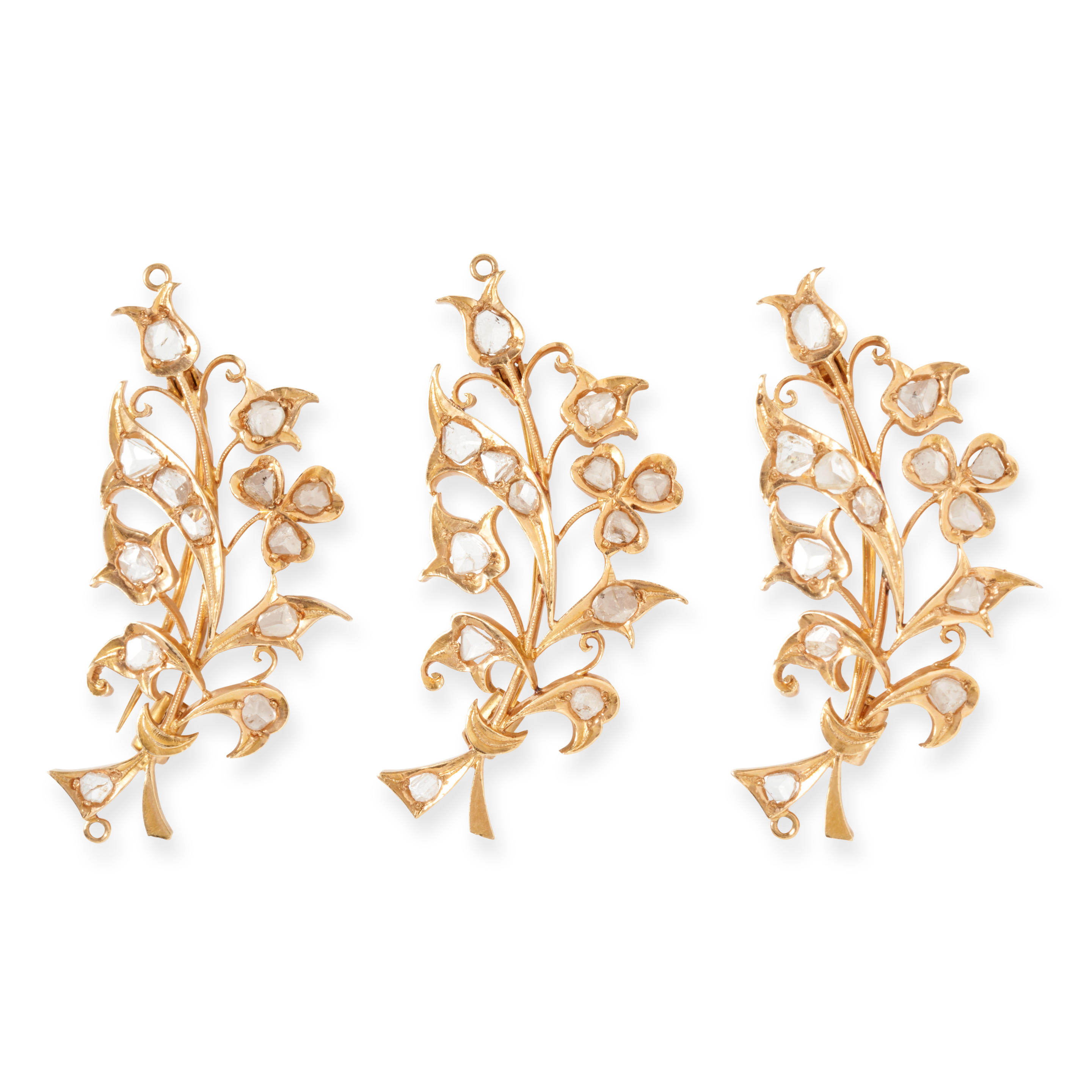 Appraisal: A SUITE OF THREE GOLD AND DIAMOND BROOCHES The spray