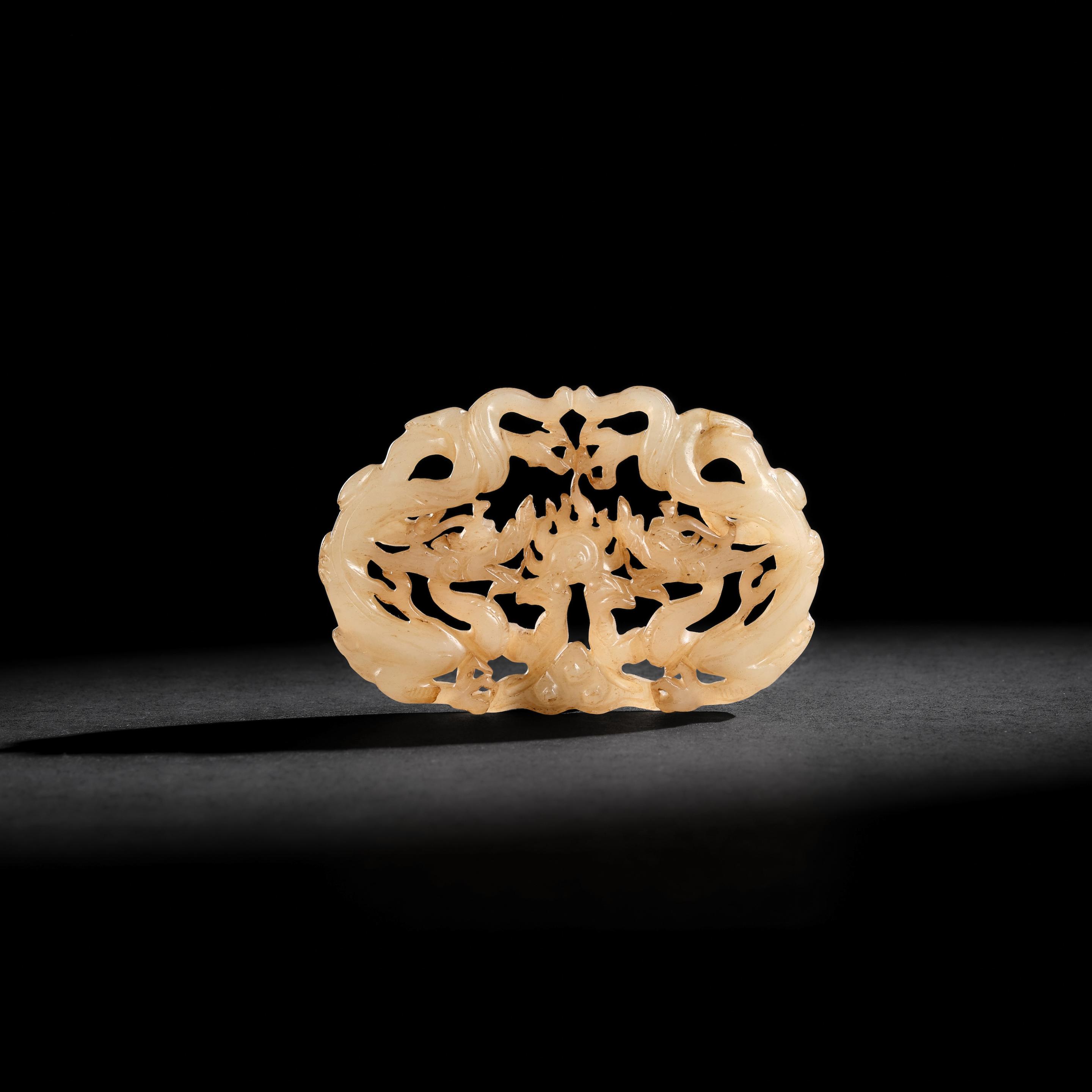 Appraisal: A RETICULATED PALE GREEN JADE 'DRAGON' PLAQUE Yuan Dynasty cm