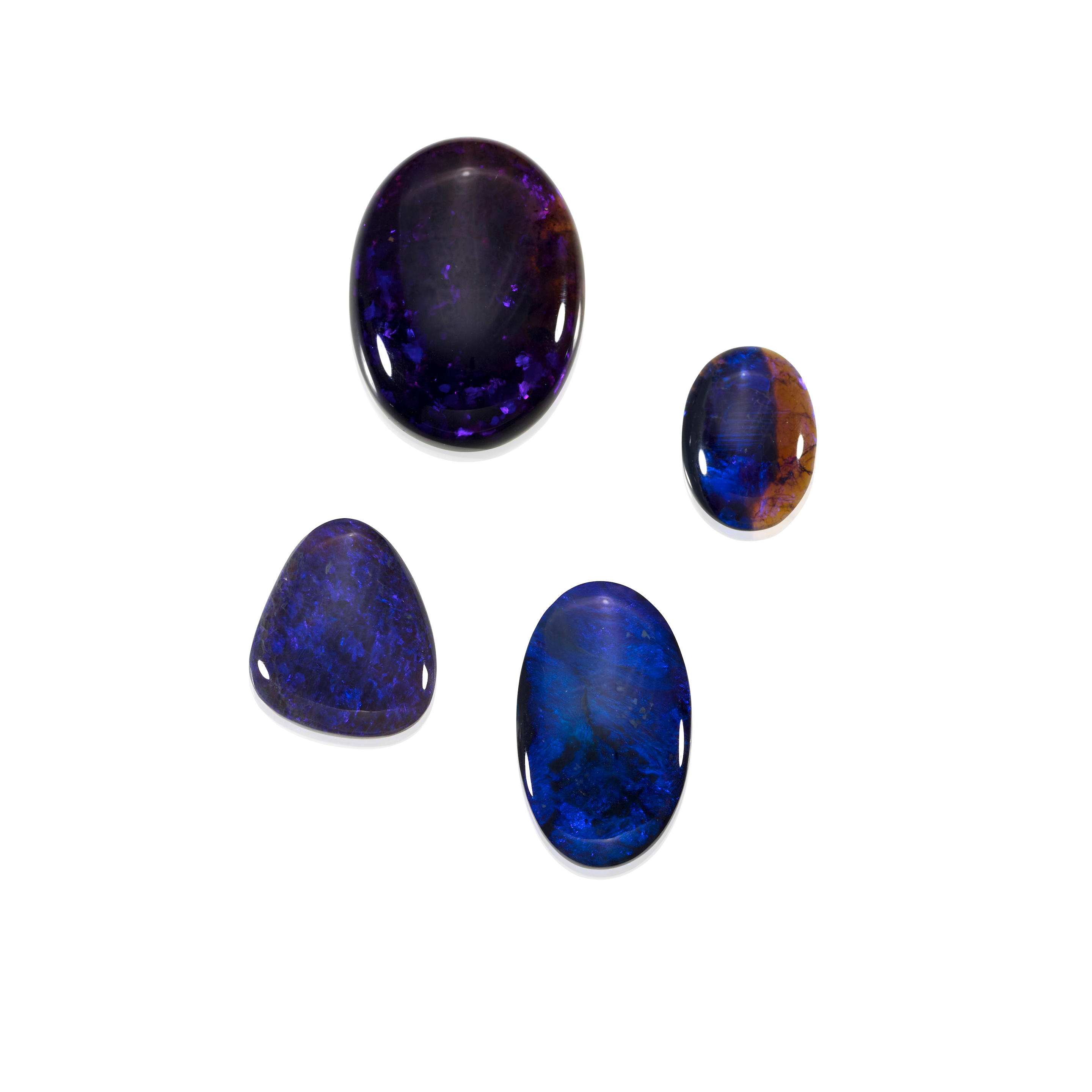 Appraisal: FOUR BLACK OPALS WITH BLUE PLAY-OF-COLOR Australia Four black opal