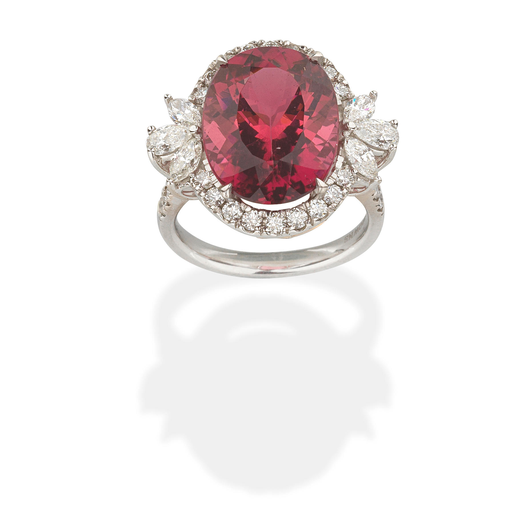 Appraisal: BROWNS TOURMALINE AND DIAMOND CLUSTER RING The oval-cut pink tourmaline