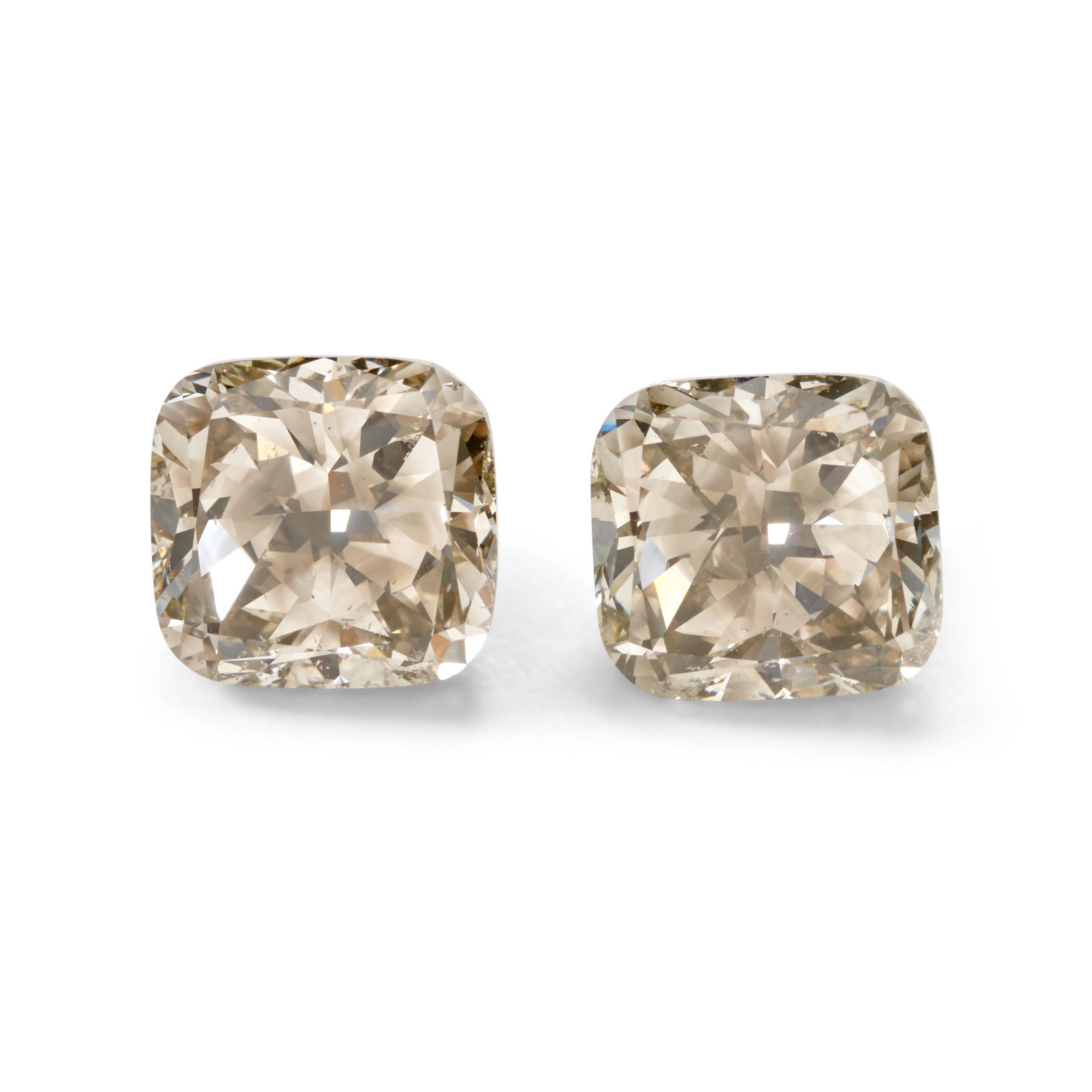 Appraisal: A PAIR OF UNMOUNTED COLORED DIAMONDS The cushion modified brilliant-cut