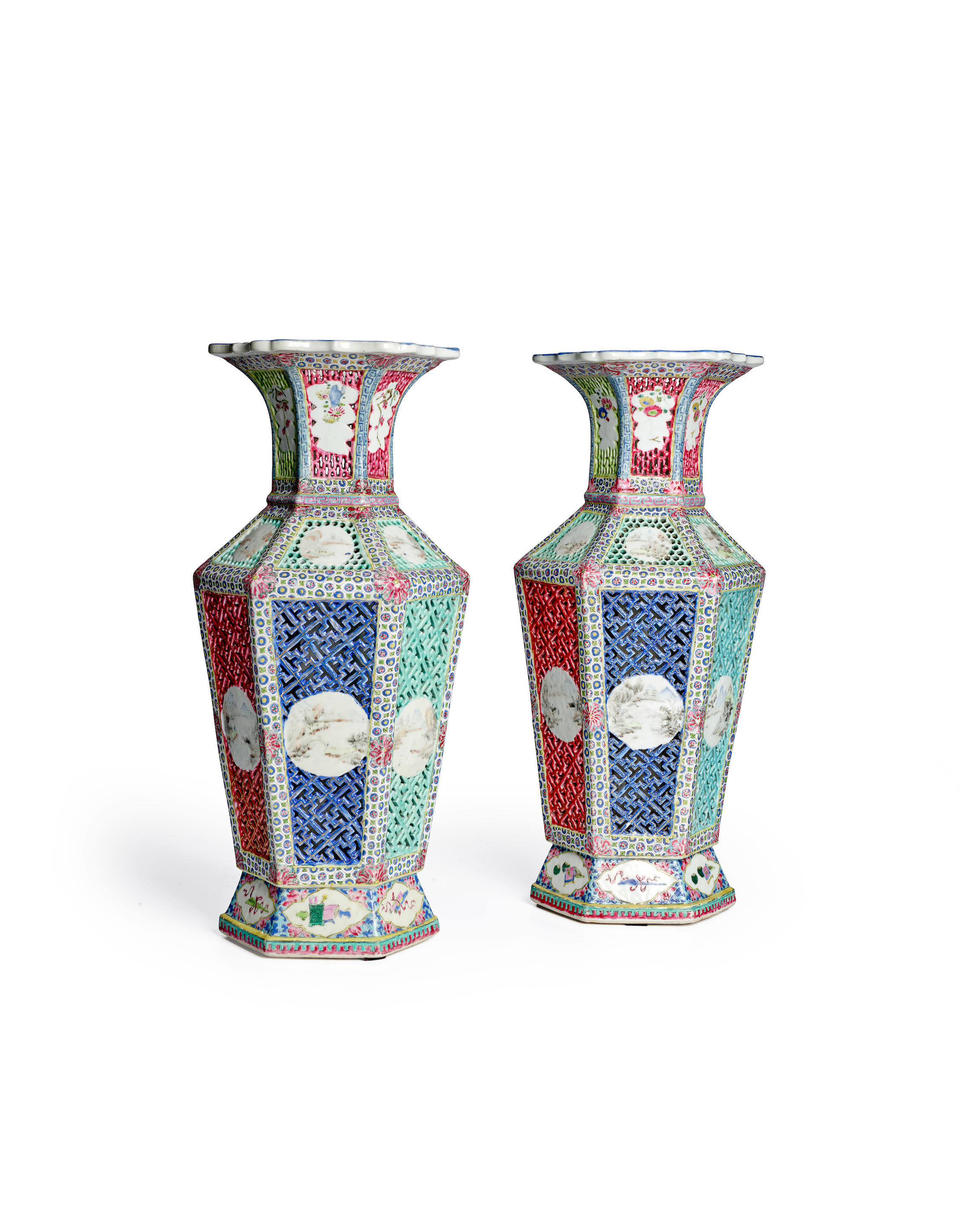 Appraisal: A PAIR OF FAMILLE ROSE DOUBLE-WALLED RETICULATED HEXAGONAL BALUSTER VASES