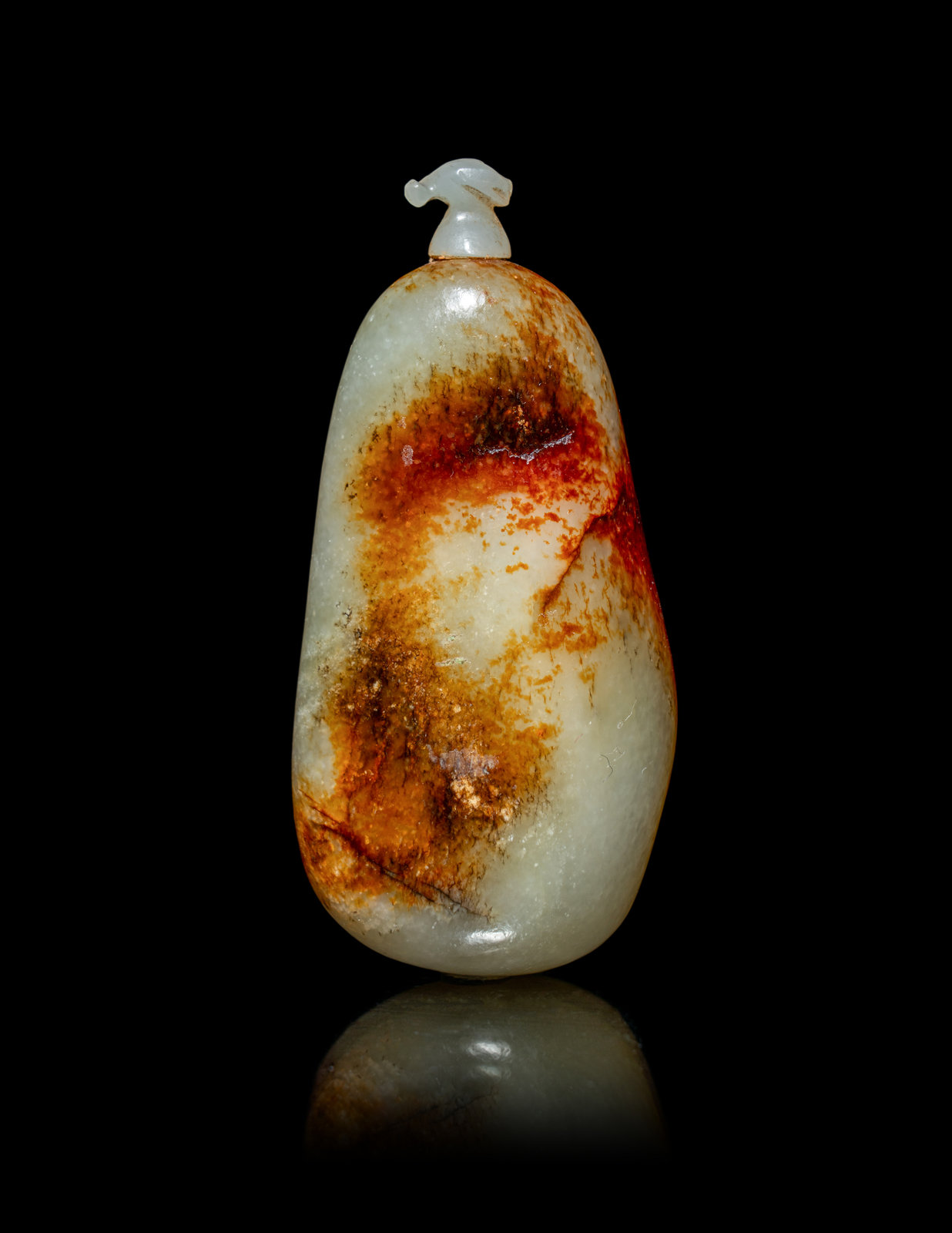 Appraisal: A Chinese Russet and Pale Celadon Jade Pebble-Form Snuff Bottle