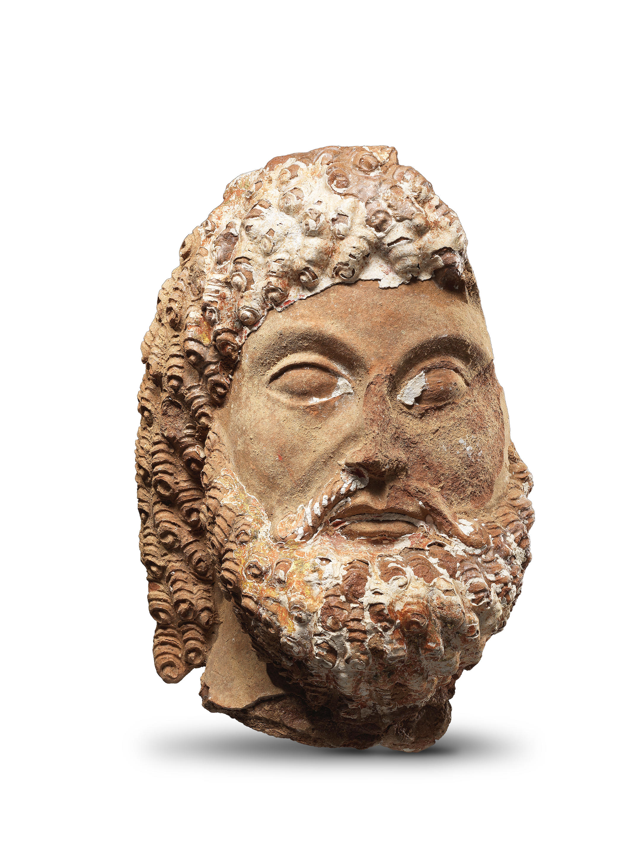 Appraisal: A GREEK TERRACOTTA GESSO PAINTED BEARDED MALE HEAD A Greek