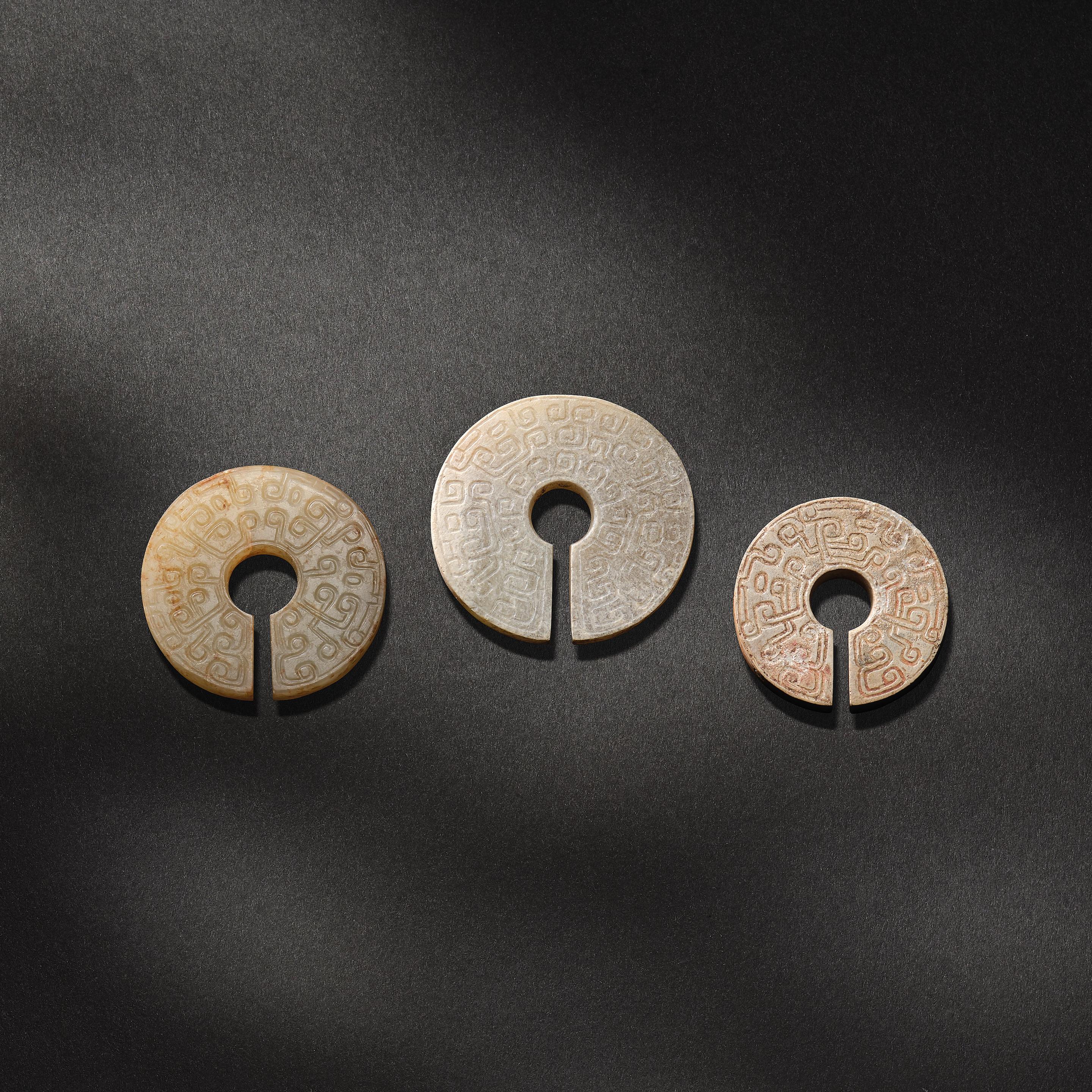 Appraisal: A GROUP OF THREE JADE SLIT DISCS JUE Eastern Zhou