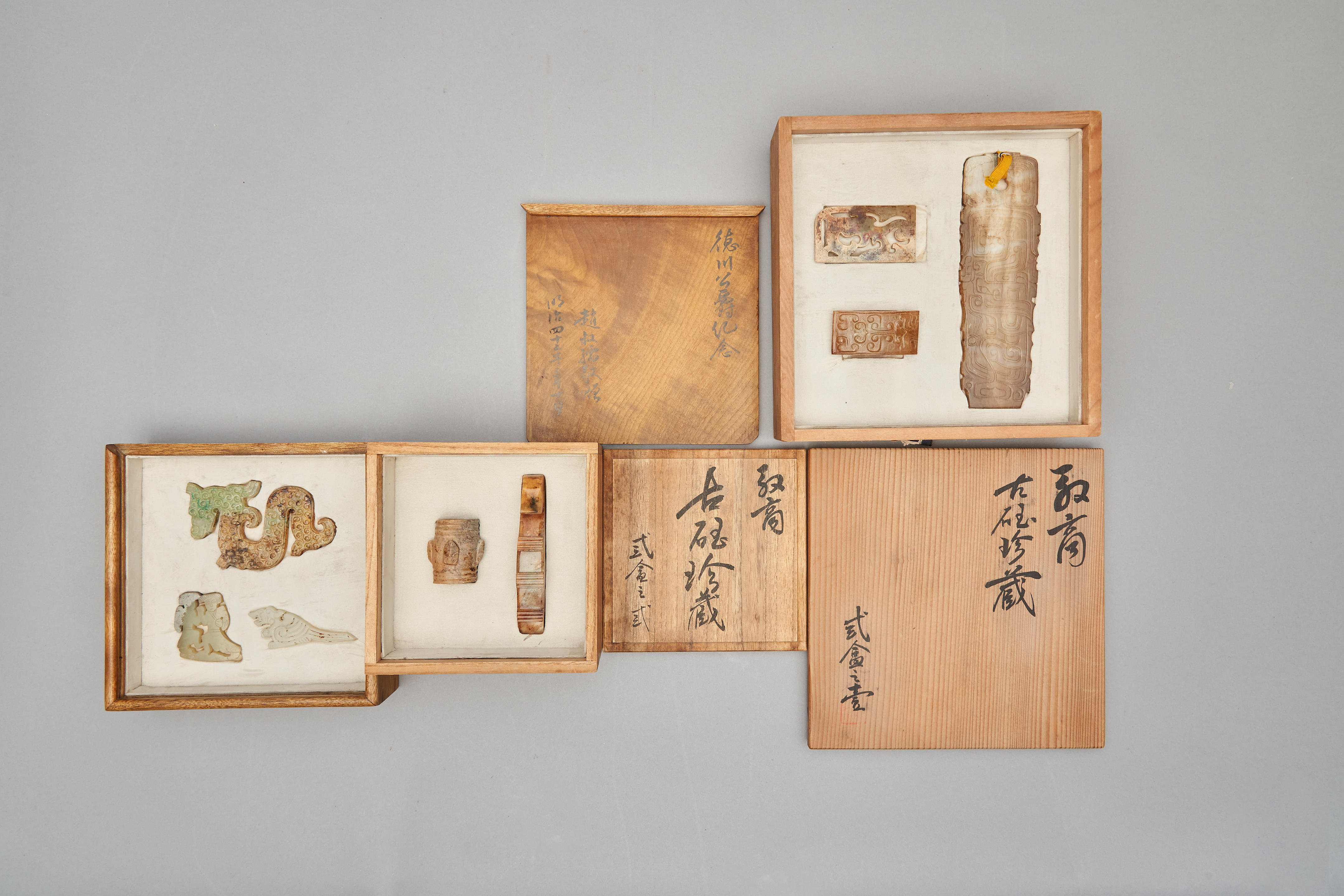 Appraisal: A SUITE OF EIGHT ARCHAISTIC JADE CARVINGS separated in three