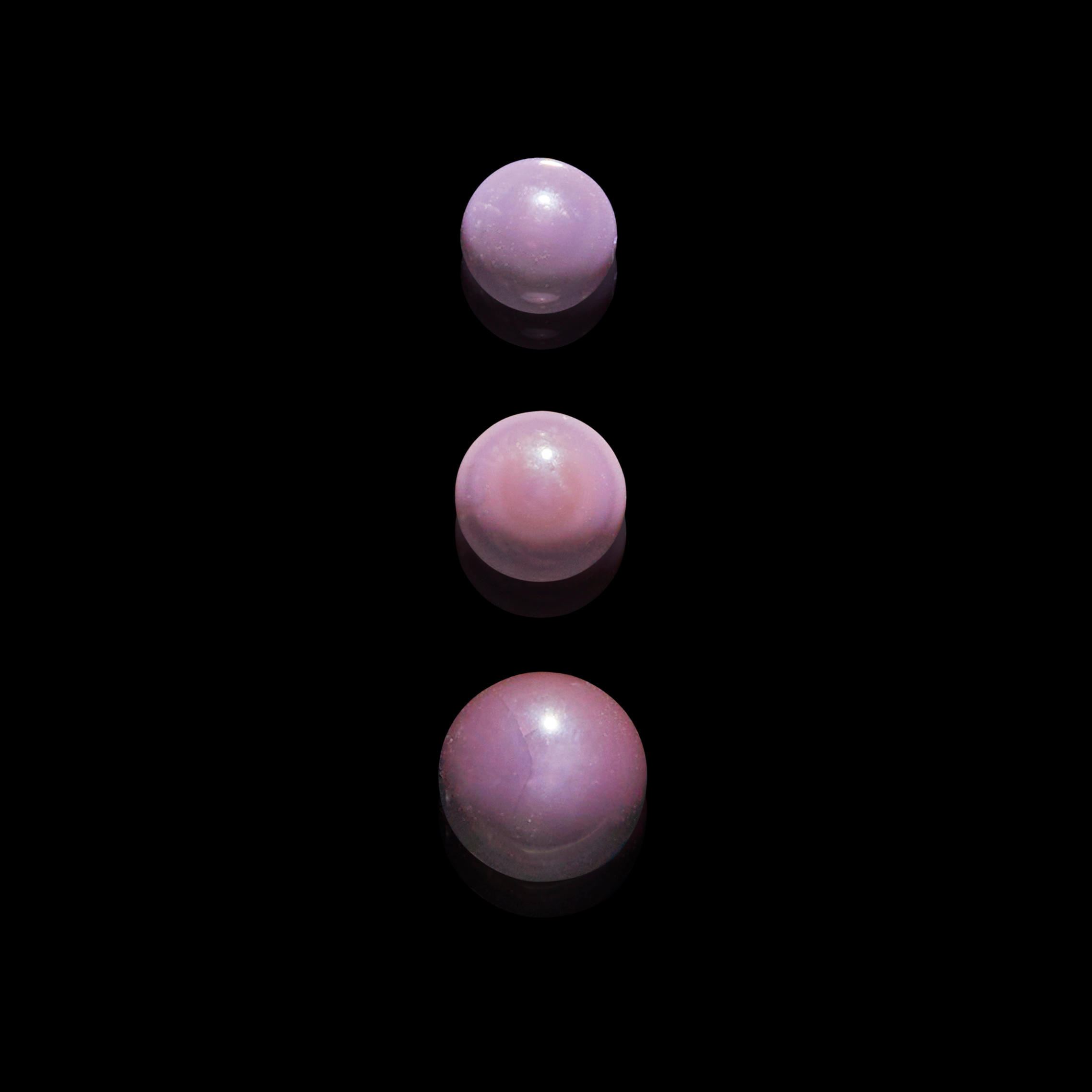 Appraisal: THREE DARK PURPLE NON-NACREOUS PEARLS-- QUAHOG PEARL Mercenaria mercenaria Northern