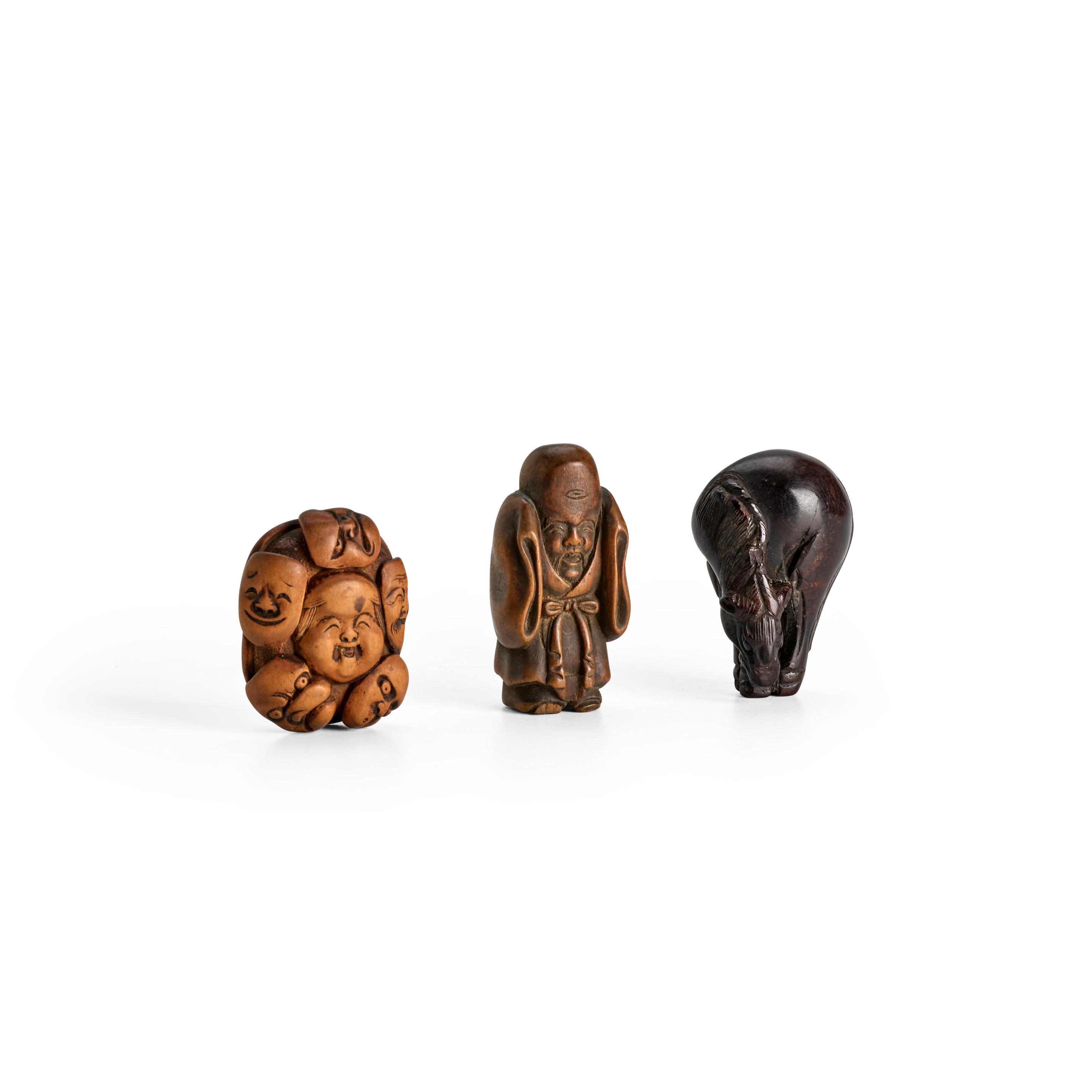 Appraisal: A GROUP OF THREE WOOD NETSUKE Edo period - th