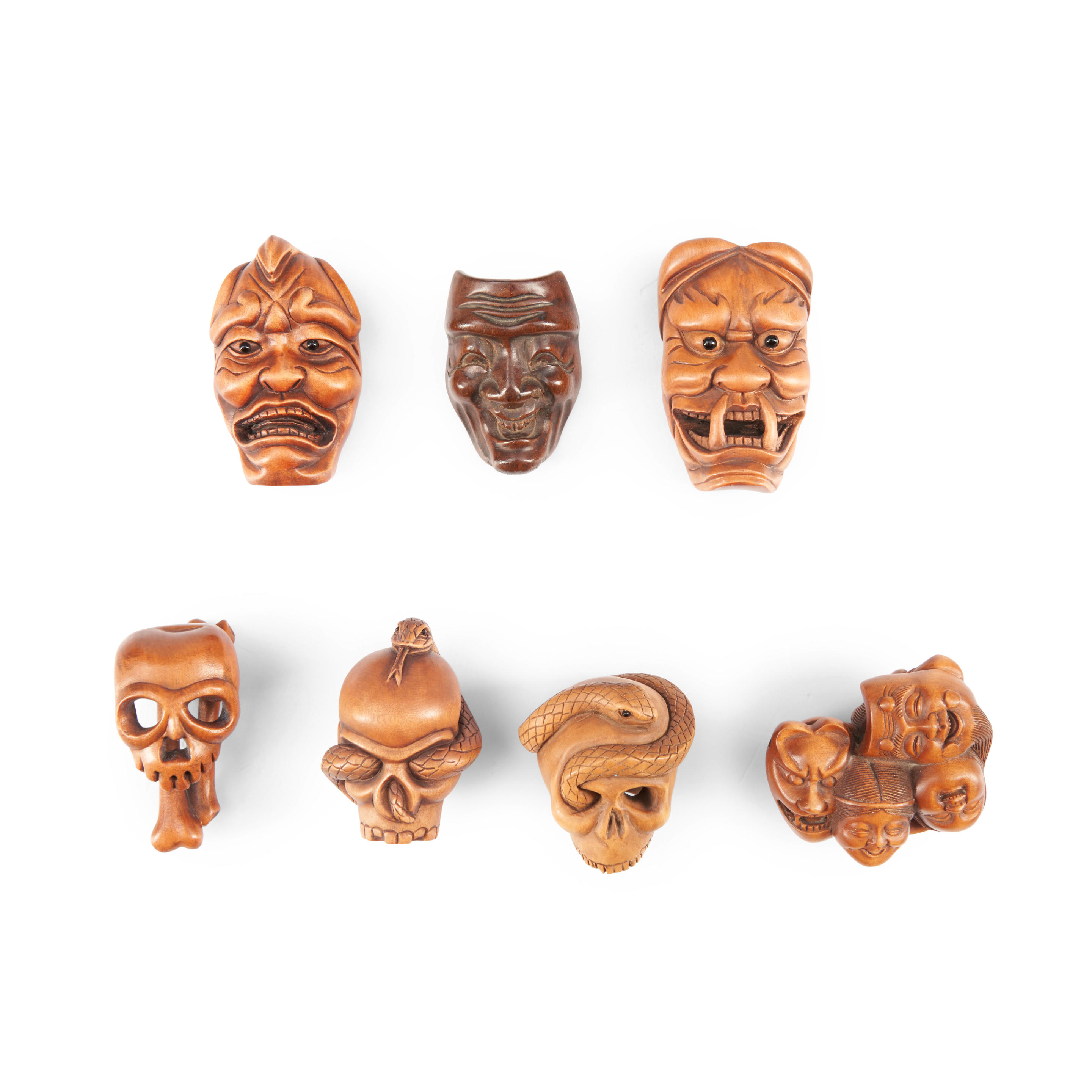 Appraisal: SEVEN WOOD NETSUKE OF 'NOH' MASKS AND SKULLS Japan late