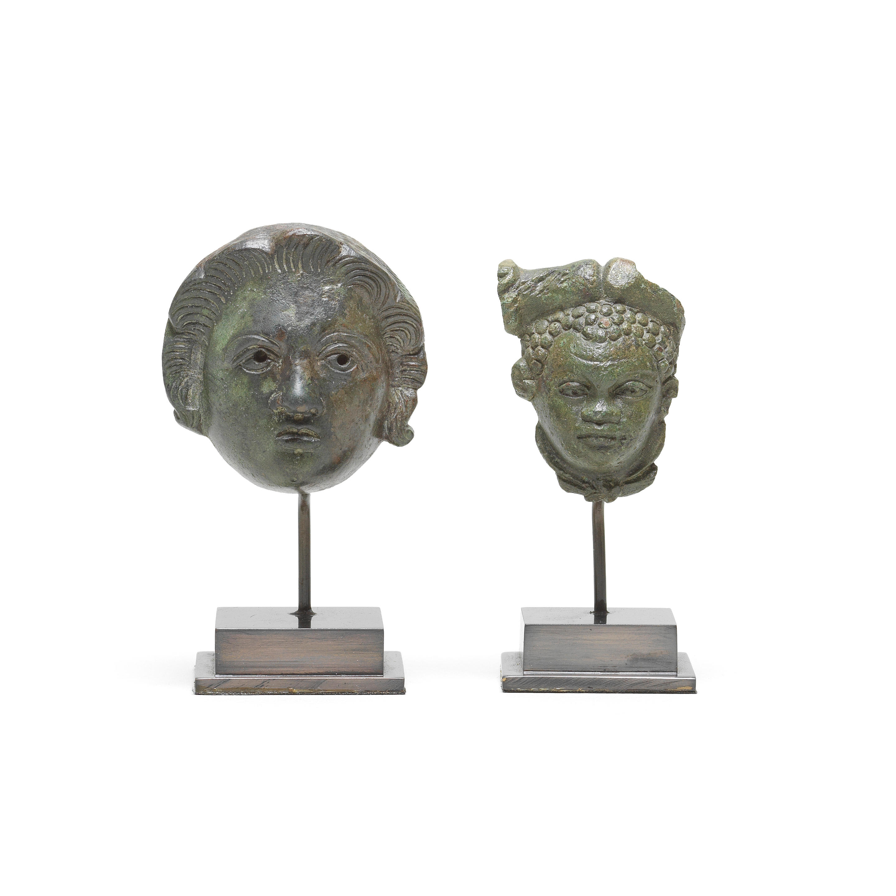 Appraisal: TWO ROMAN BRONZE HEAD ATTACHMENTS Two Roman bronze head attachments