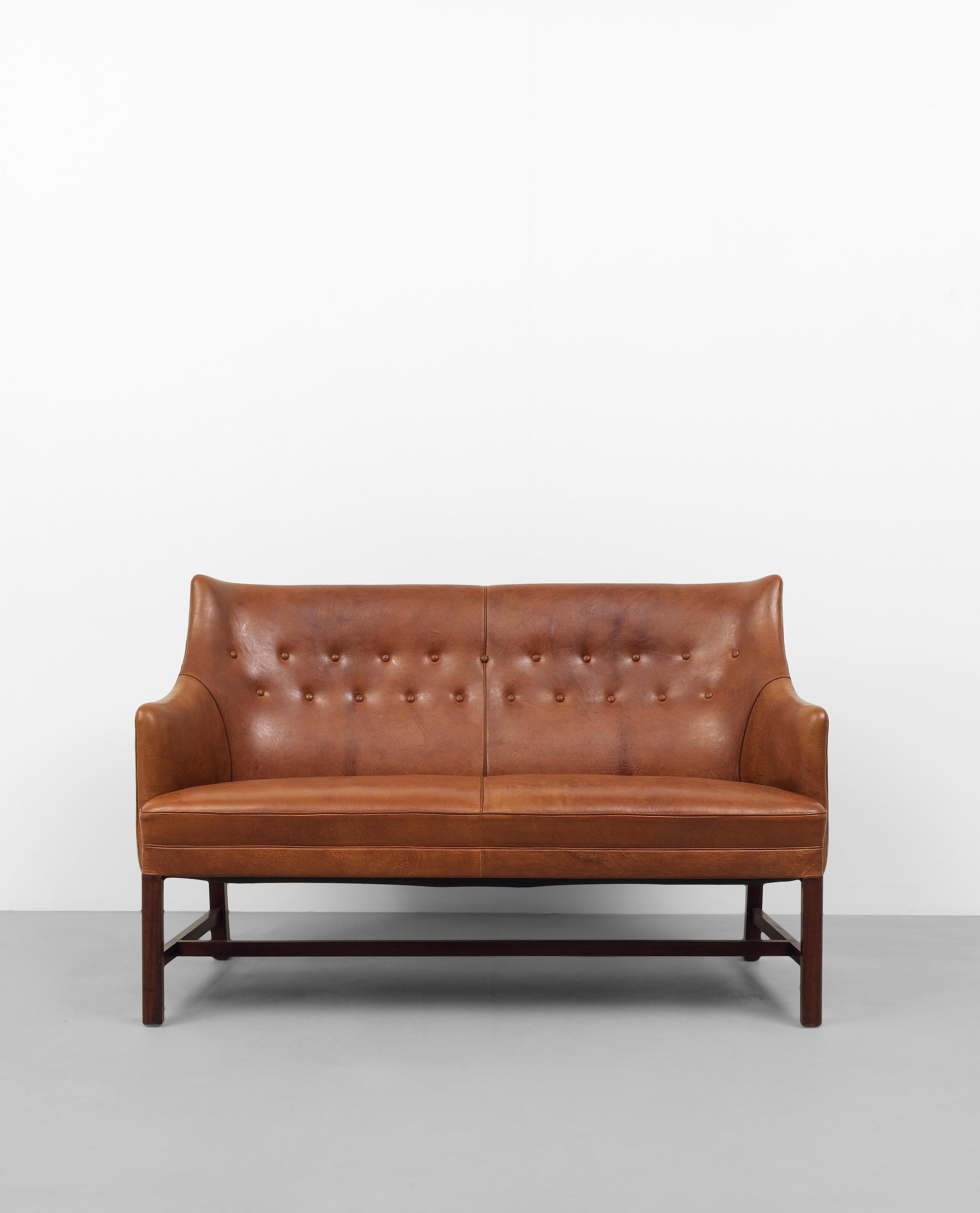 Appraisal: FRITS HENNINGSEN Sofa early s Mahogany leather upholstery x x