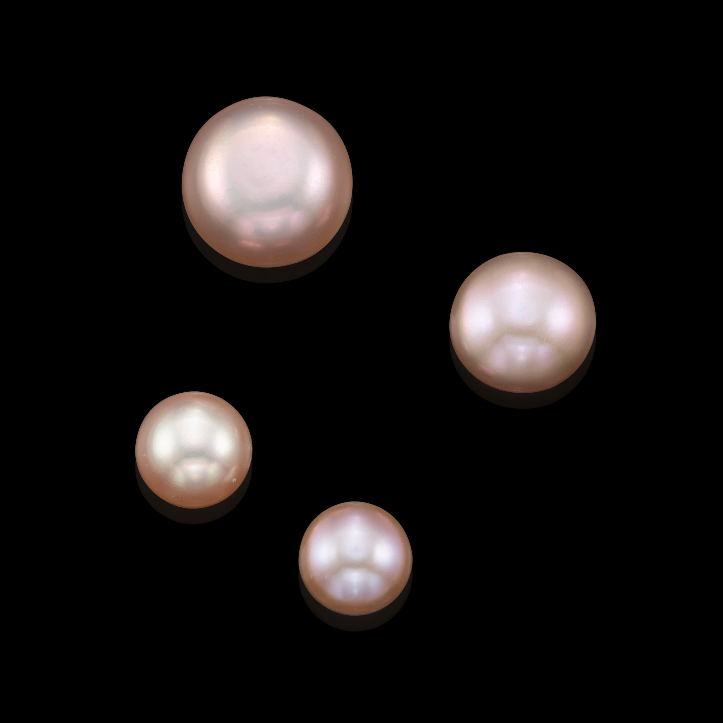 Appraisal: FOUR BUTTON-FORM FRESHWATER PEARLS Hyriopsis cumingii China The largest a