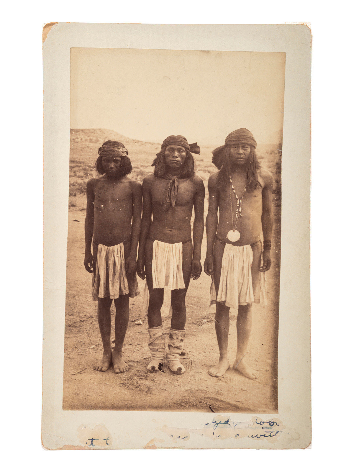 Appraisal: NATIVE AMERICANS Boudoir card of three Apache men wearing loin