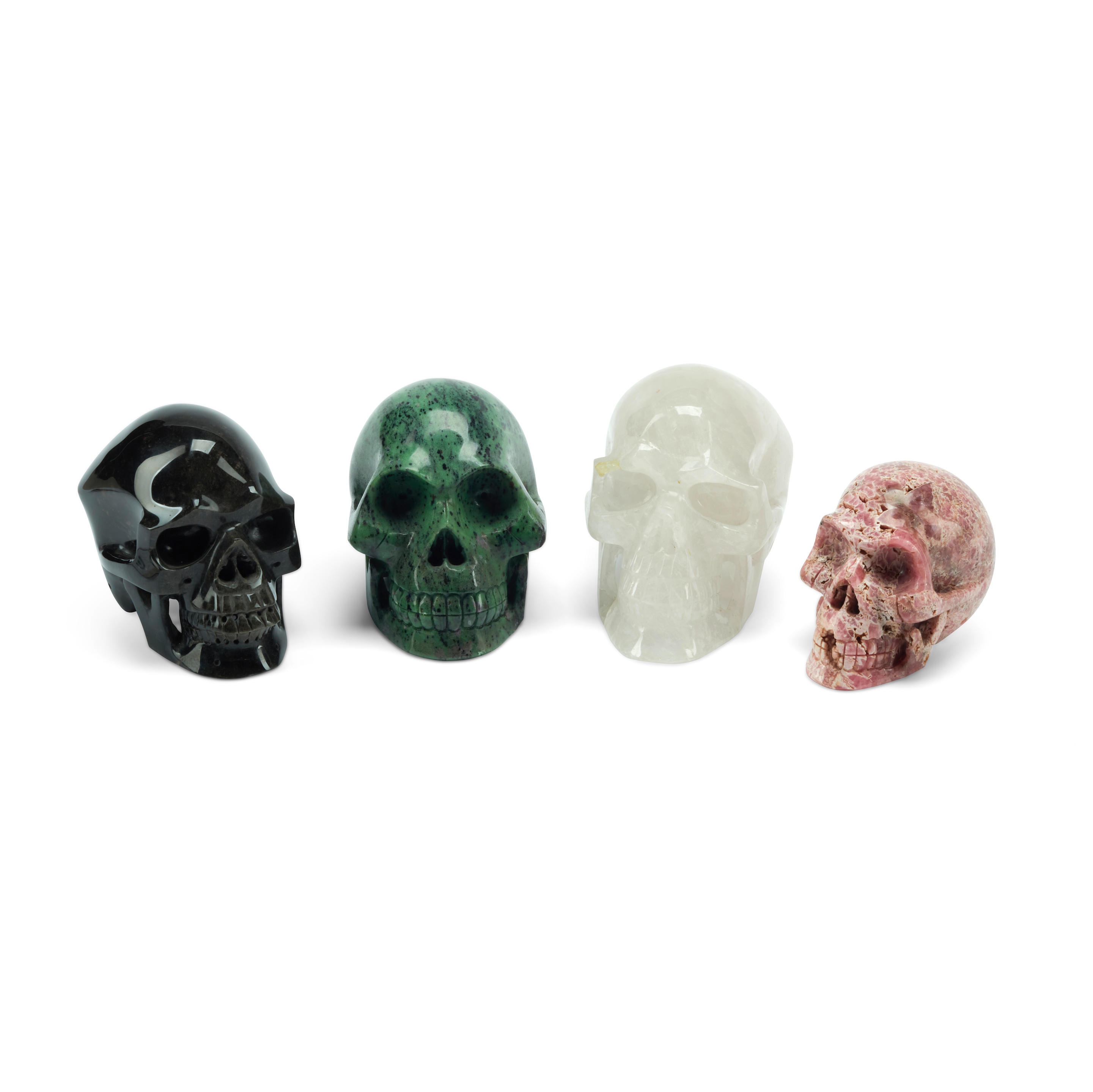 Appraisal: A GROUP OF FOUR CARVED MINERAL SPECIMEN SKULLS One rock