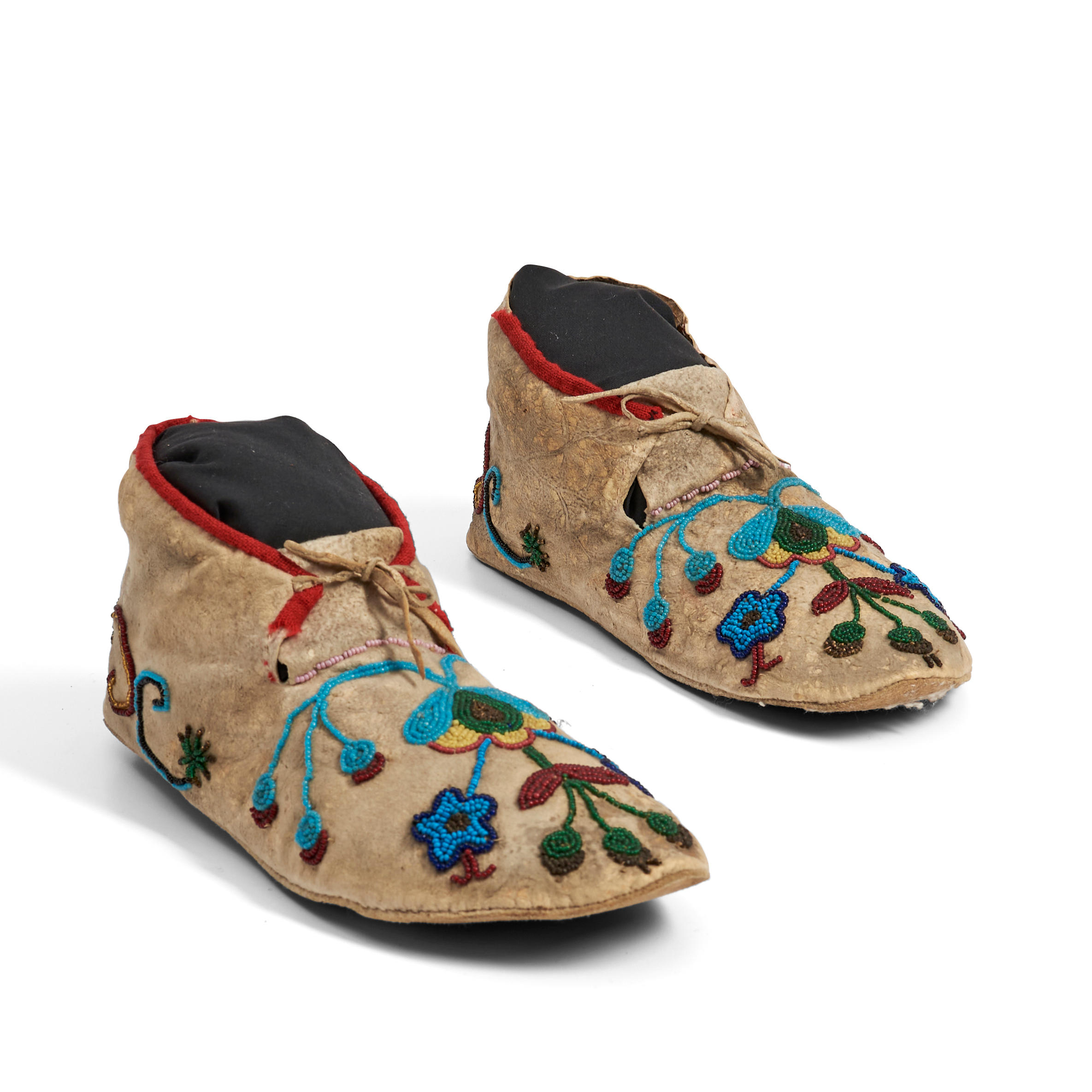 Appraisal: A PAIR OF SANTEE SIOUX BEADED HIDE MOCCASINS Fourth quarter