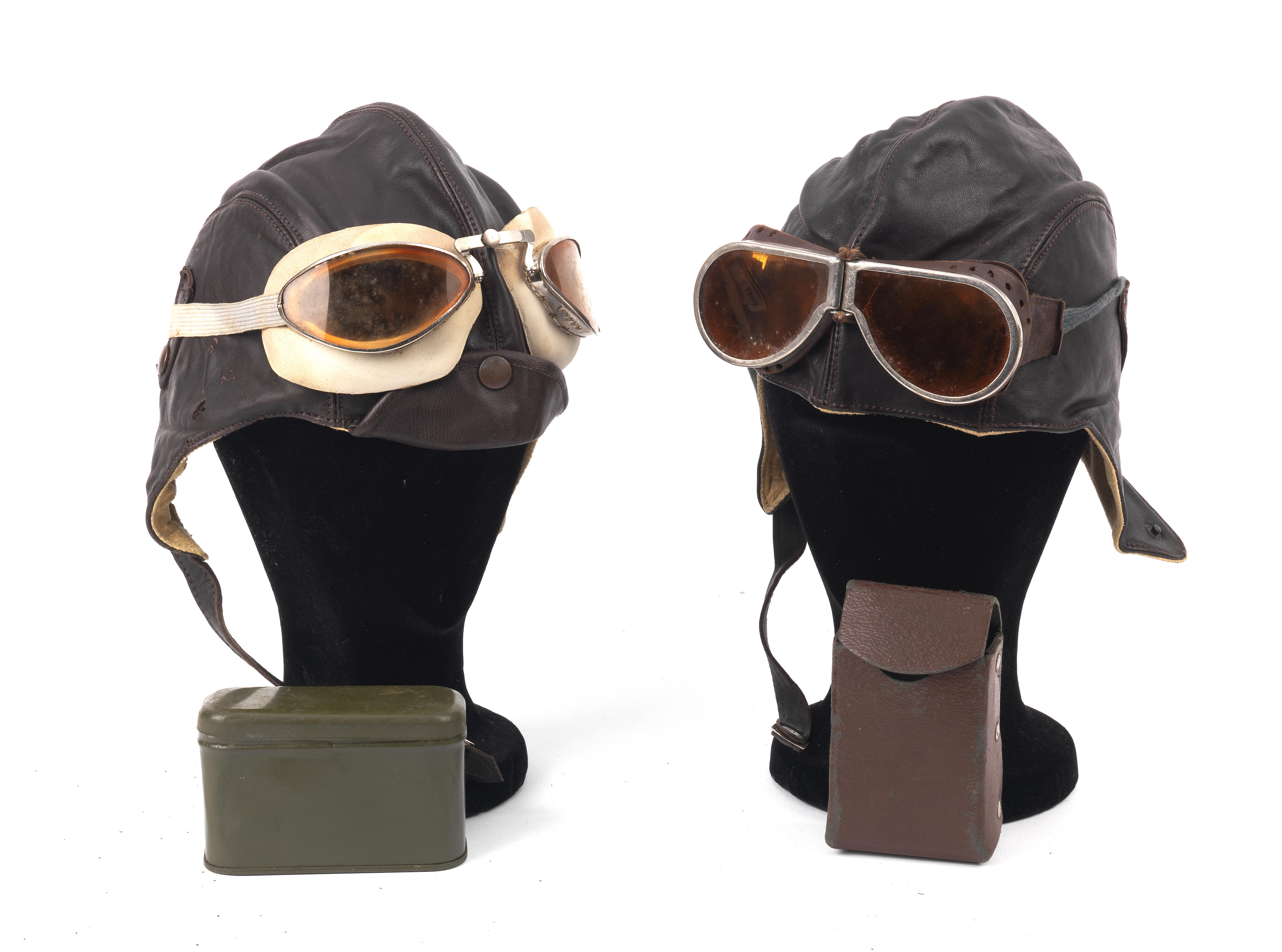 Appraisal: TWO LEATHER HELMETS AND TWO PAIRS OF DRIVING GOGGLES TO