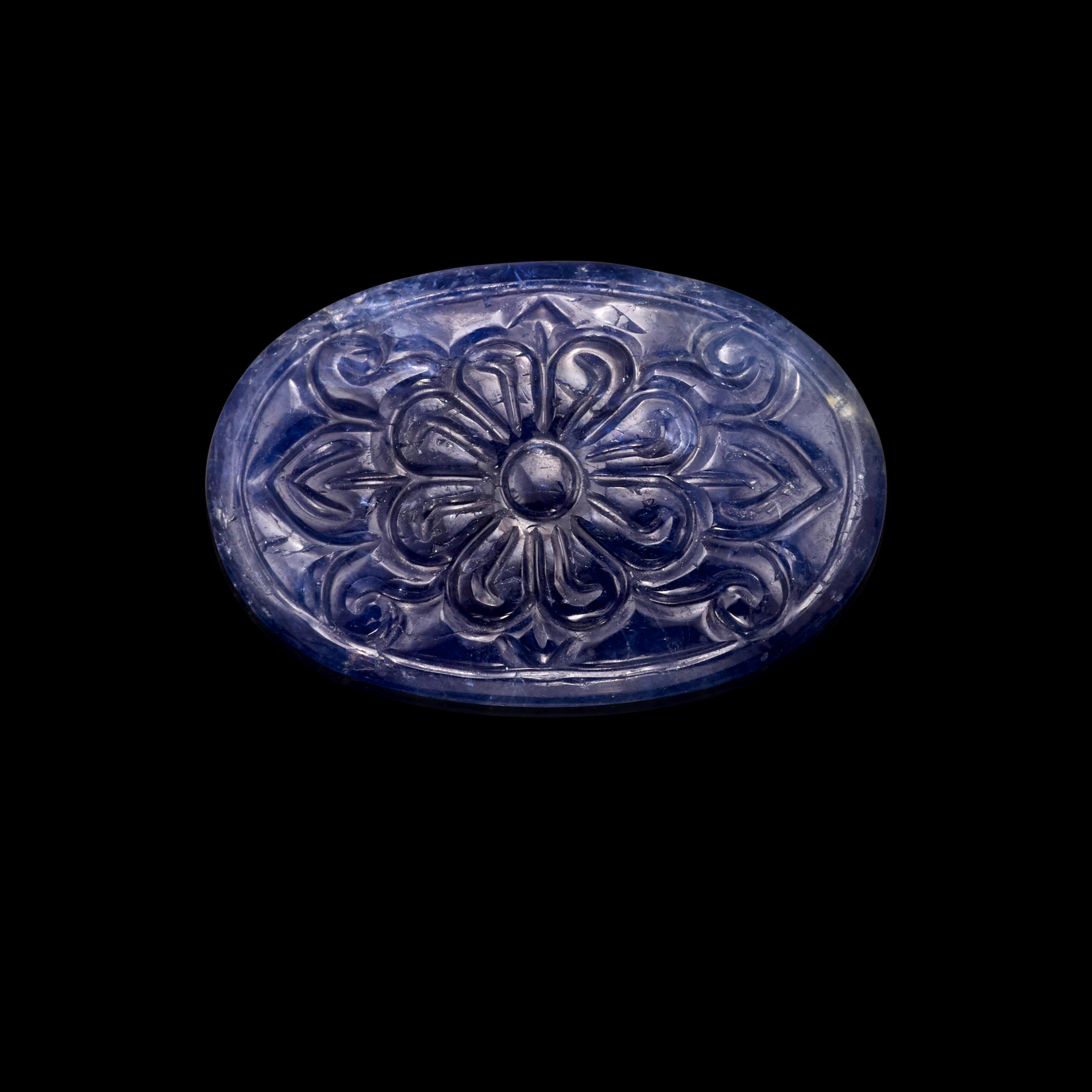 Appraisal: BLUE SAPPHIRE CARVED CABOCHON An oval double-sided cabochon of blue