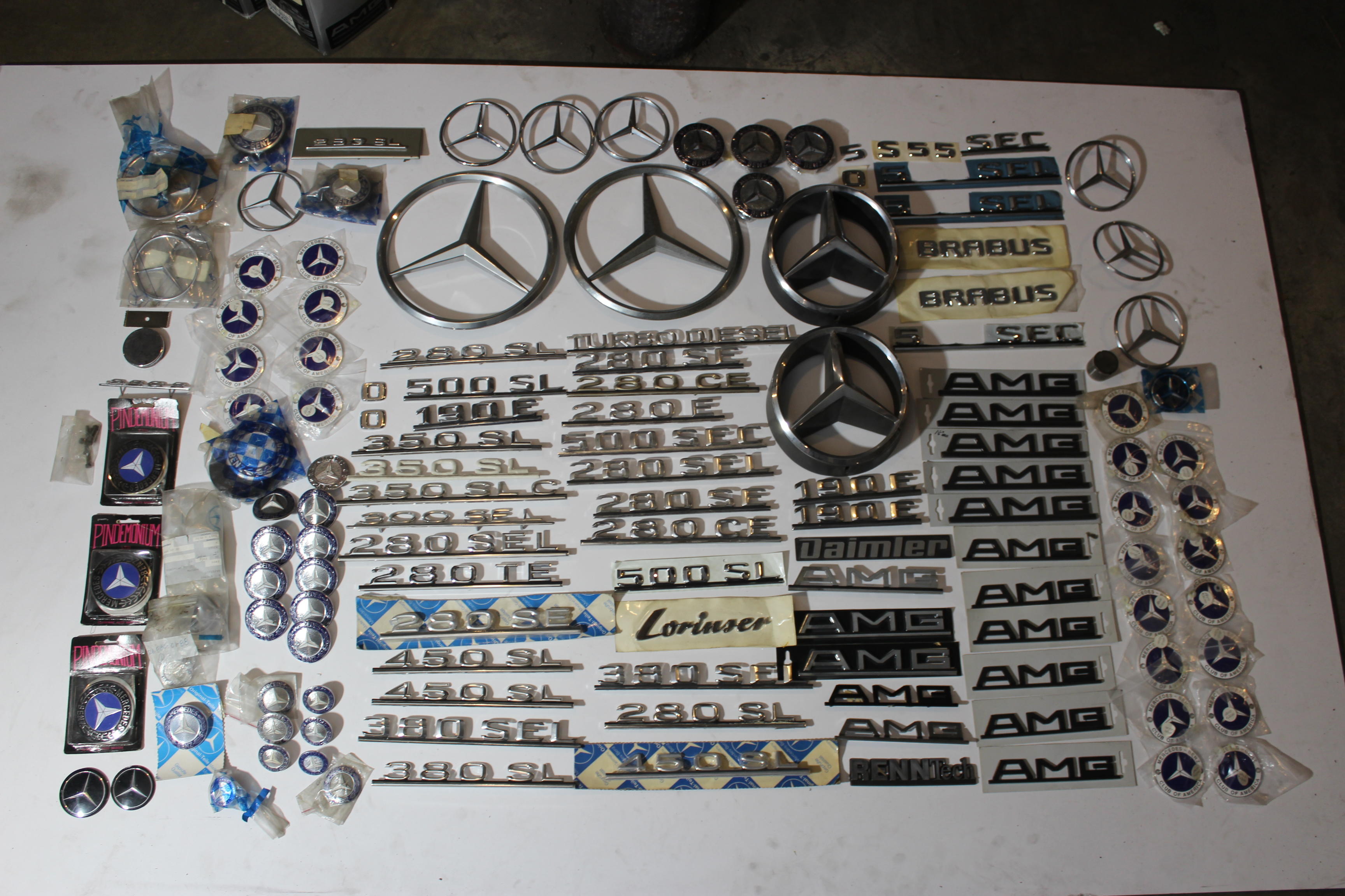 Appraisal: A LARGE GROUPING OF CHROME TONE MERCEDES-BENZ BADGES TOGETHER WITH