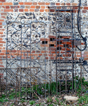 Appraisal: Two old wrought iron single garden gates with scrolled panels