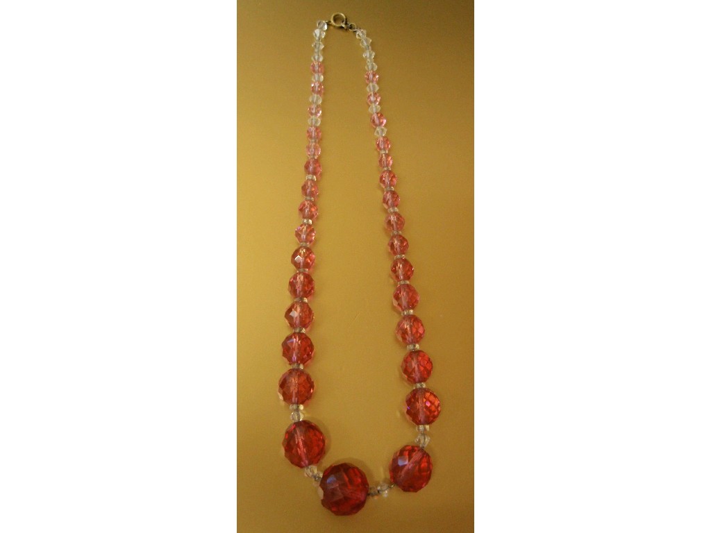 Appraisal: A pink and white glass necklace with graduated facetted beads