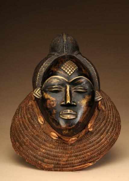 Appraisal: African Mask Description Made of bronze raffia cowry shells and