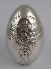 Appraisal: A Russian silver cased Easter egg with embossed figures marked