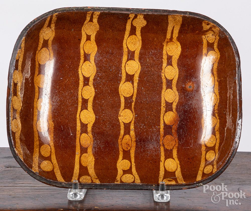 Appraisal: English slip decorated redware loaf dish th c English slip