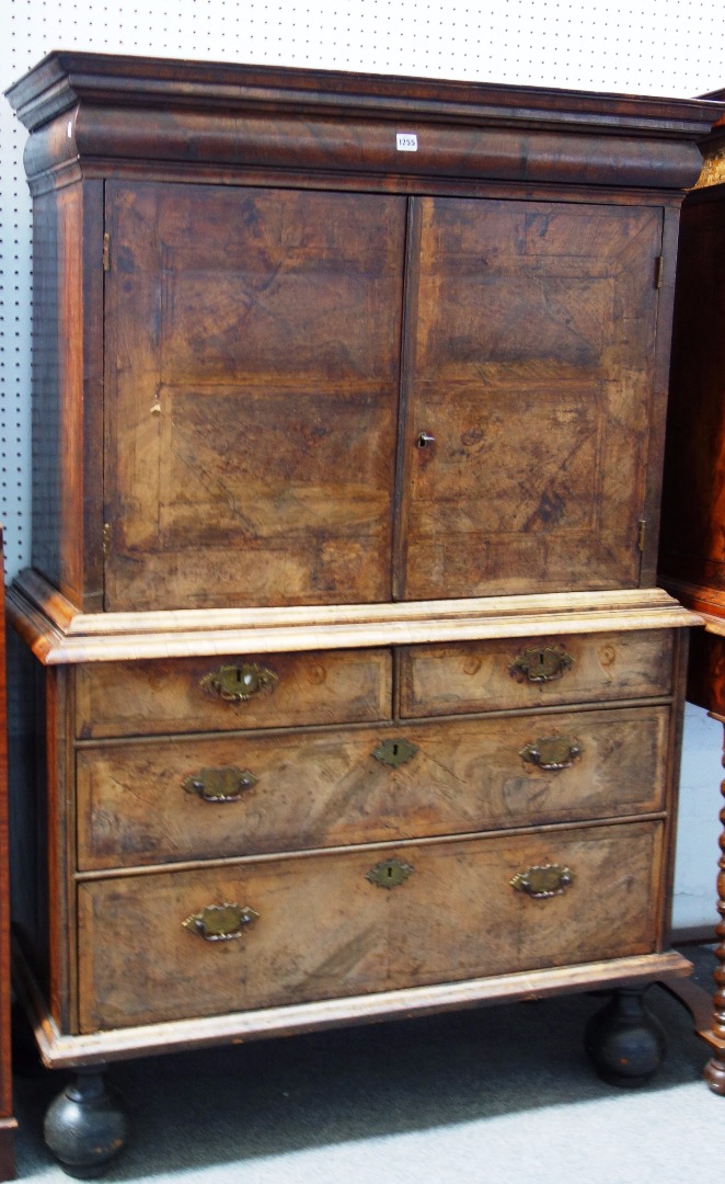 Appraisal: An early th century figured walnut cabinet on chest with