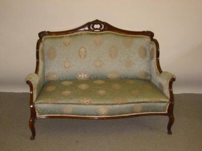 Appraisal: A VICTORIAN WALNUT FRAMED SOFA upholstered in an eau de