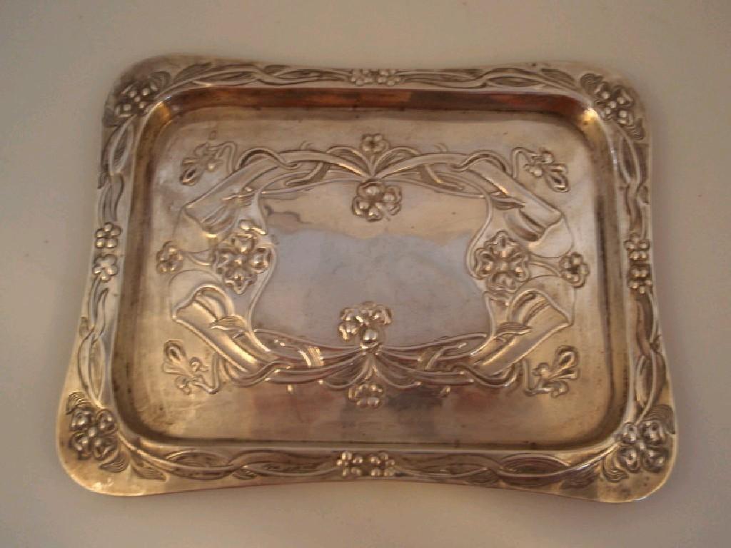 Appraisal: An Edwardian silver rectangular tray with raised flat border embossed