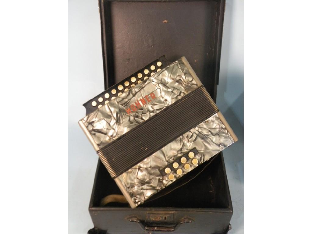 Appraisal: A Hohner piano accordion with a grey simulated marble decoration