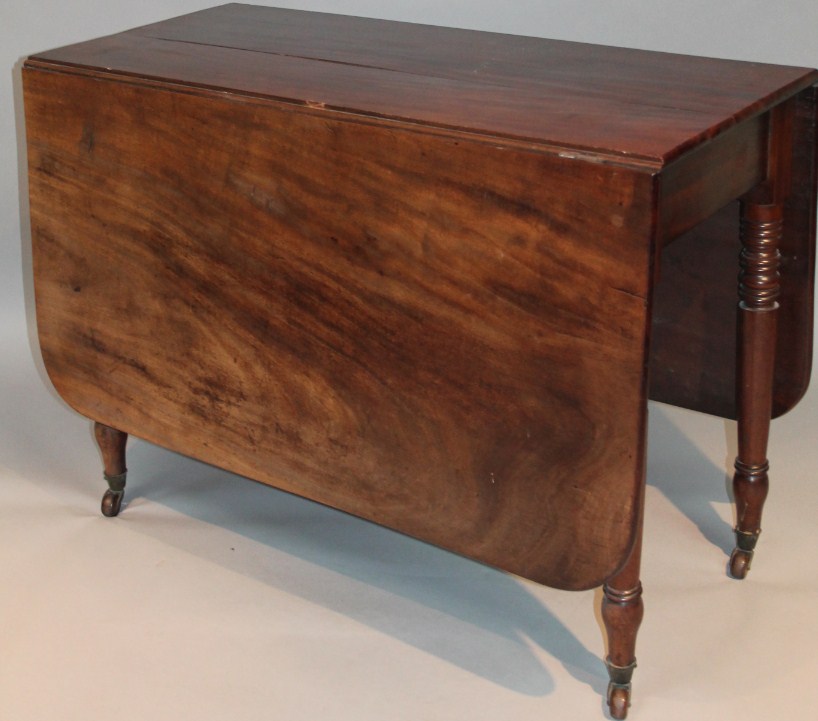 Appraisal: A thC mahogany drop leaf table the rounded top raised