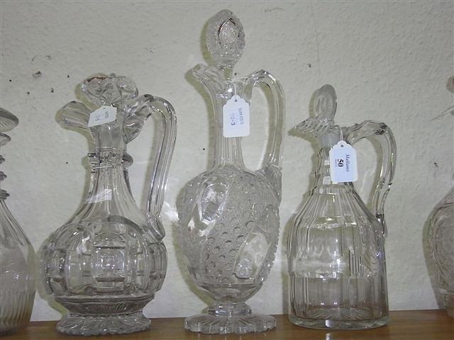 Appraisal: THREE TH CENTURY GLASS CLARET JUGS with stoppers