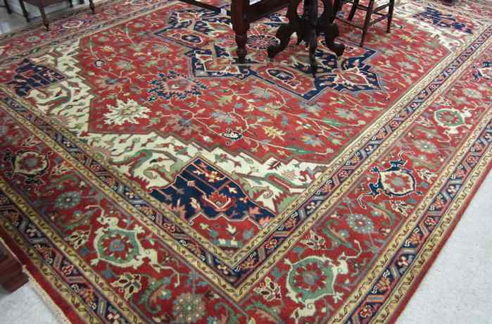 Appraisal: HAND KNOTTED ORIENTAL CARPET Persian Serapi design the stylized floral