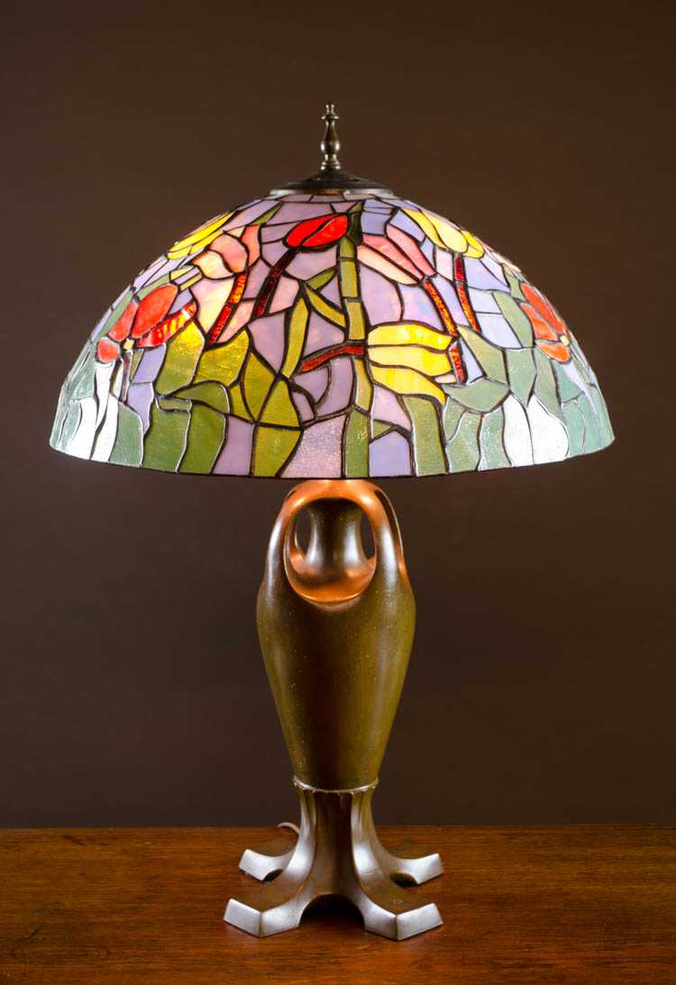 Appraisal: HANDEL PATINATED METAL TABLE LAMP with stained and leaded glass