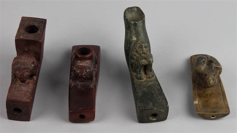 Appraisal: FOUR CATLINITE AND STEATITE EFFIGY PIPES th C reproductions catlinite