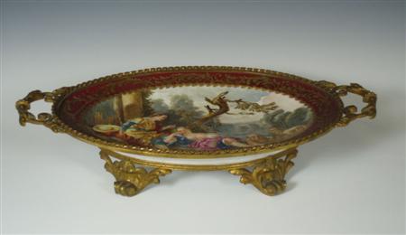 Appraisal: A Vienna style porcelain gilt metal mounted oval platter decorated