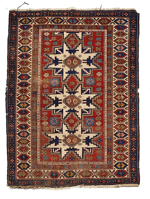 Appraisal: AN ANTIQUE CAUCASIAN LESGHI RUG with geometric central panel and